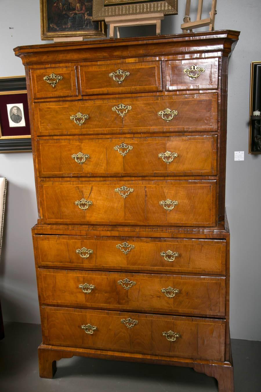 George 1 period figured chest on chest fine colour and patina. Drawers inlaid with feather banding, book matched sides. Period but replaced brasses.
English C 1720.