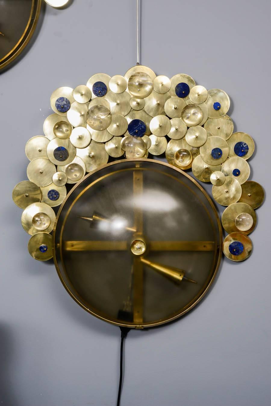 Pair of brass sconces, made of brass discs, lapi lazuli stones and rock crystal, two bulbs per sconce, created for Gallery Glustin