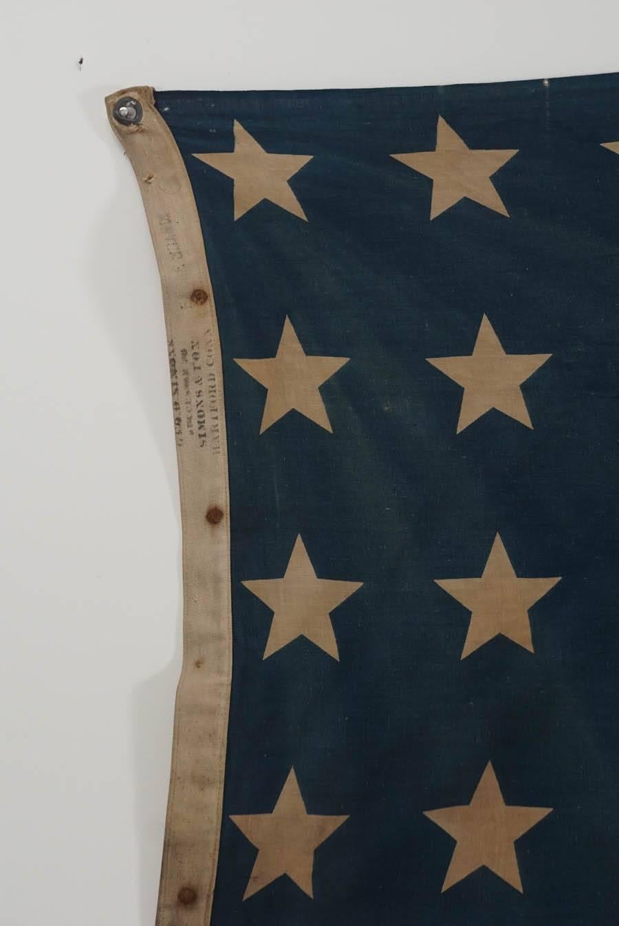 A great piece of early American history. This antique flag is waiting to be admired be any proud American. 48 stars, made in Hartford CT, by Simons & Rex. Has age, discoloration, light stains as seen in pictures and one small frey, which is not