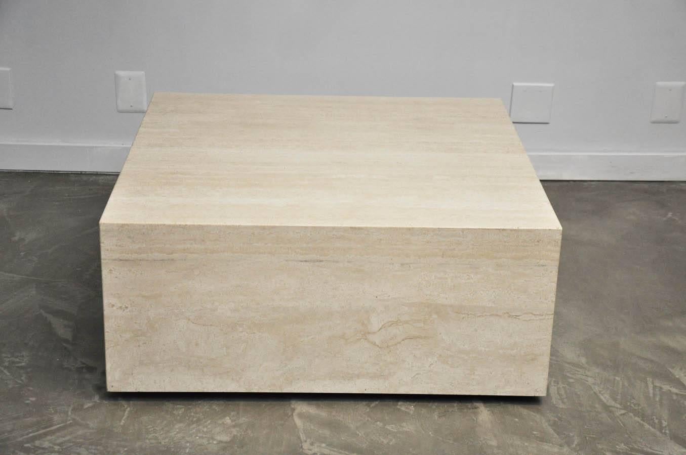 Travertine coffee table on castors for mobility.