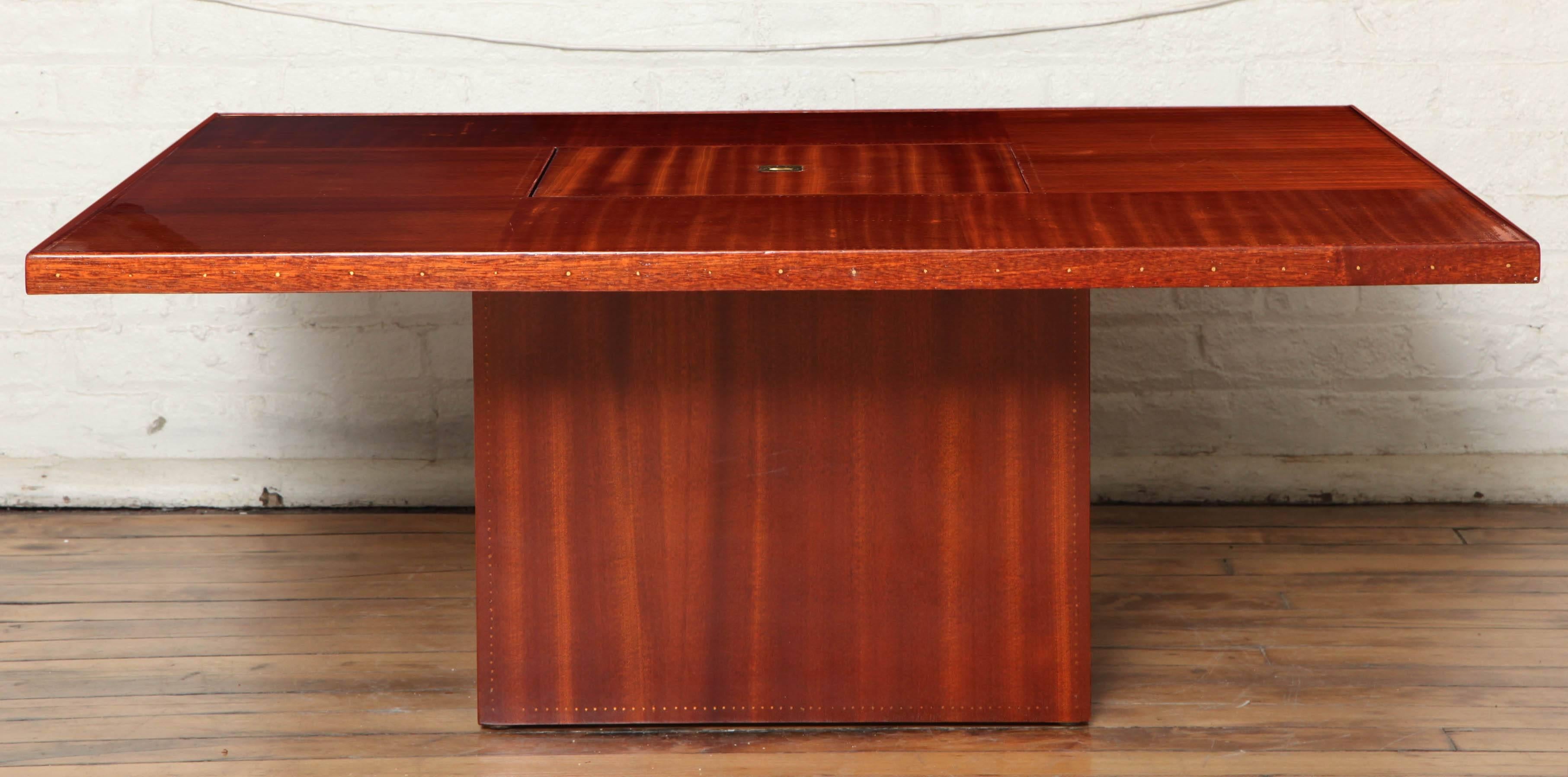 Art Deco cocktail table. Mahogany with brass nailhead details typical to Sornay's designs. Centre opens for a bar compartment. By Andre Sornay.

Bibliography Andre Sornay by Thierry Roche Page 101.