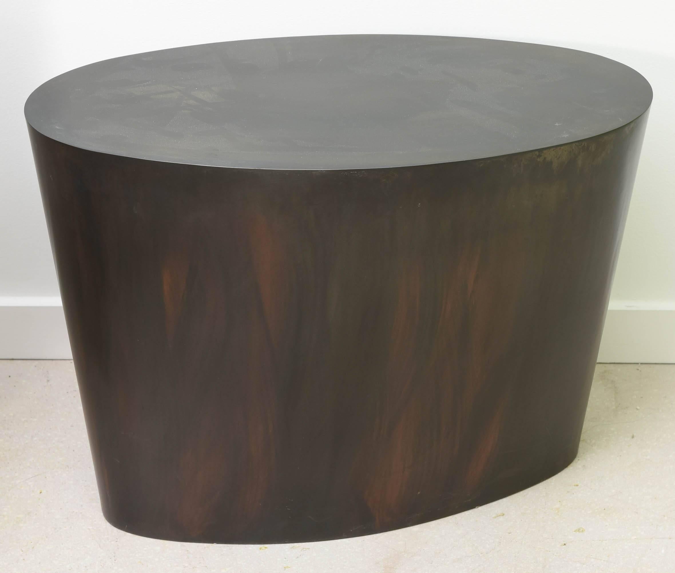 Sleek and modern steel table with bronze patina.