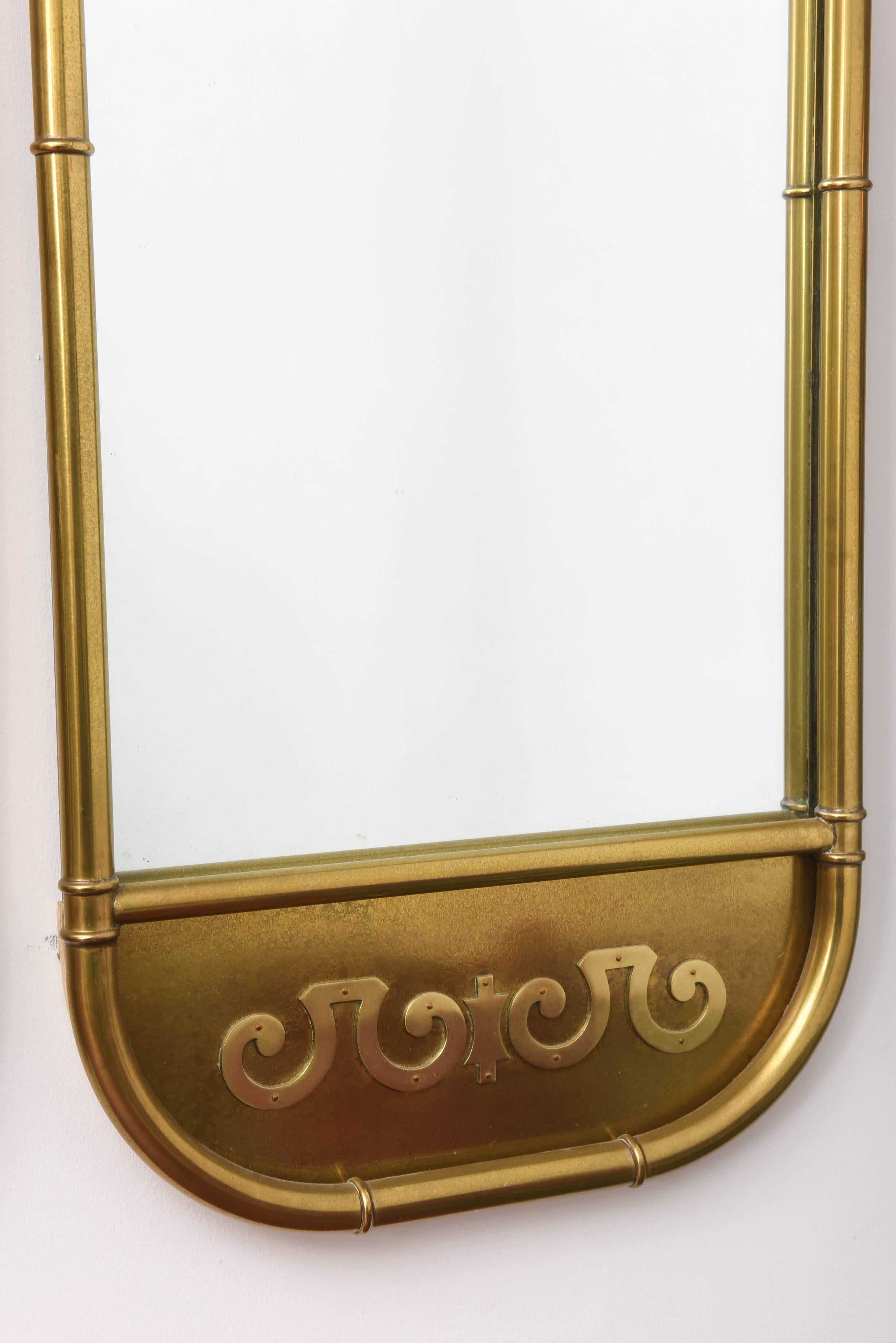 Pair of vintage rectangular brass Mastercraft mirrors with simple scroll motif.