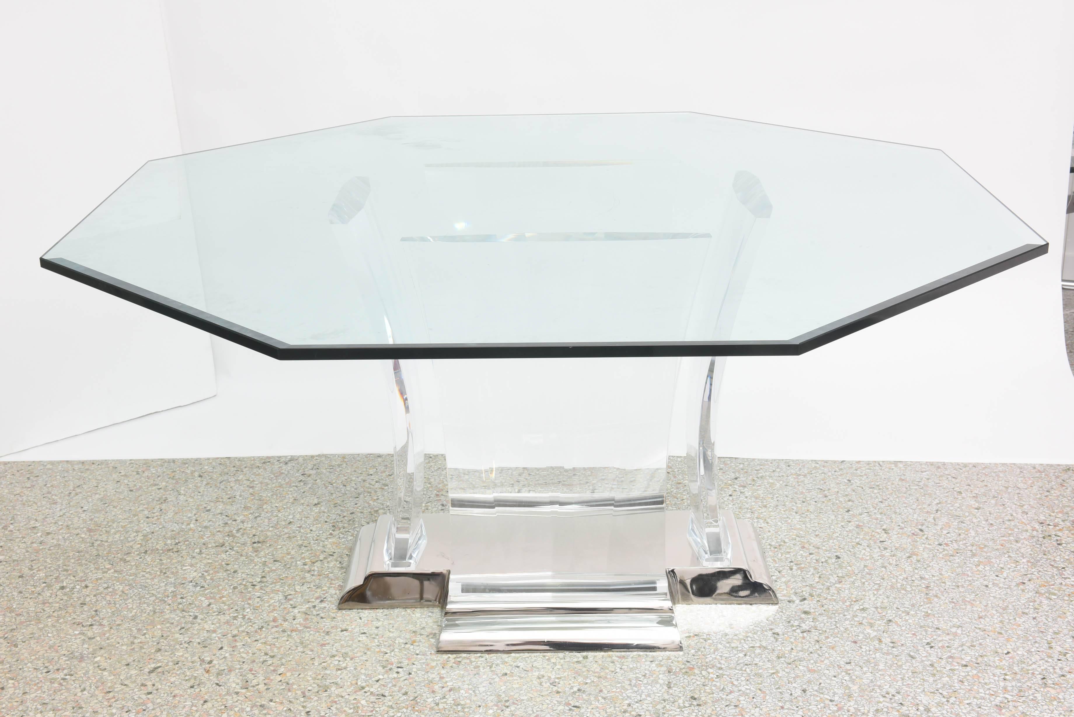This handsome octagonal-shaped dining table was designed by the iconic firm of Spectrum Limited and was produced in the 1980s.

The base is nickel-plated with four 2" thick pieces of flared Lucite supports.

The glass top is 3/4" thick