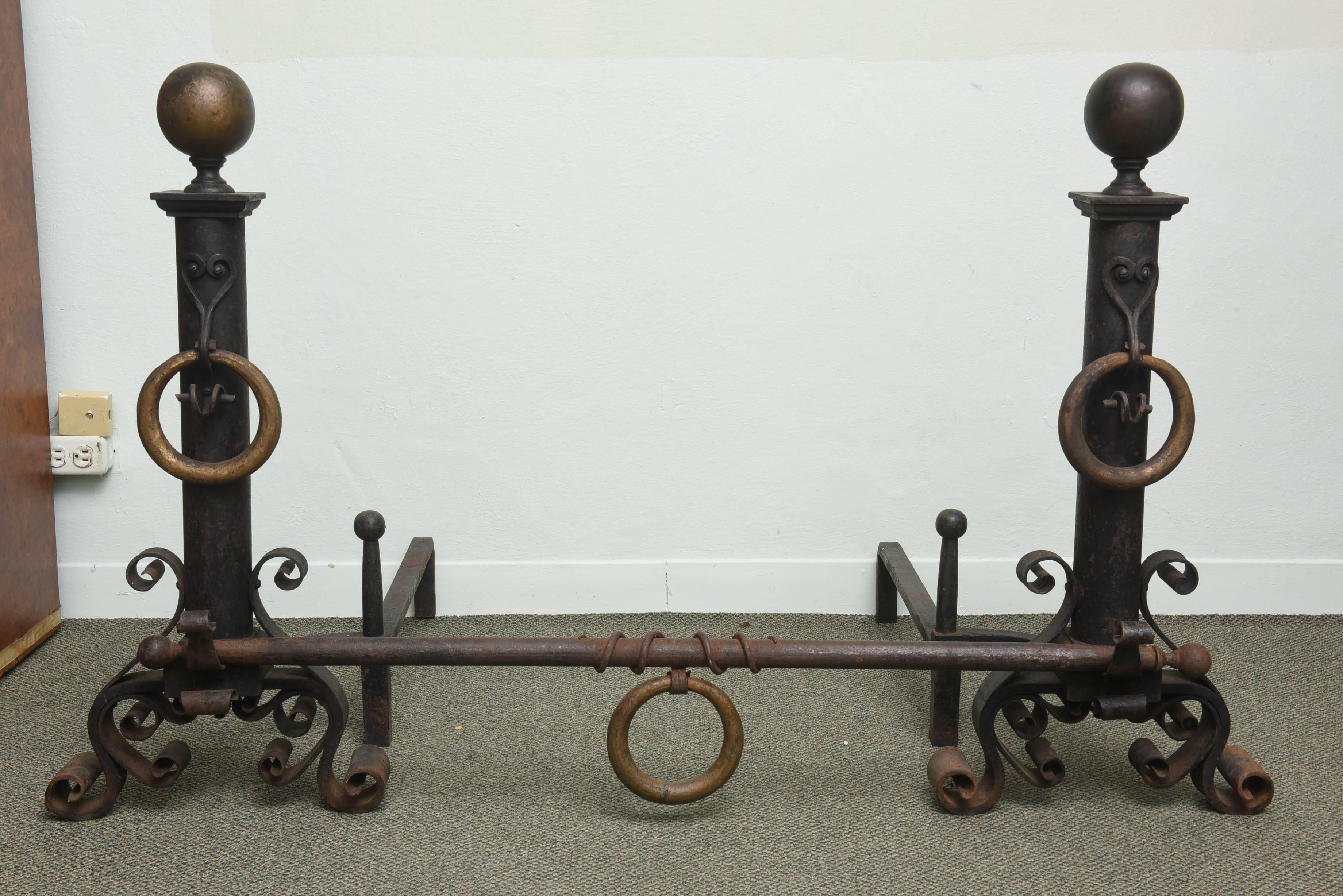 This monumental-scaled 1920s fireplace andirons are very much in the style of Addison Mizner and were acquired from a Palm Beach estate. They are hand-wrought iron in the Spanish Colonial style and will make a definite statement for your