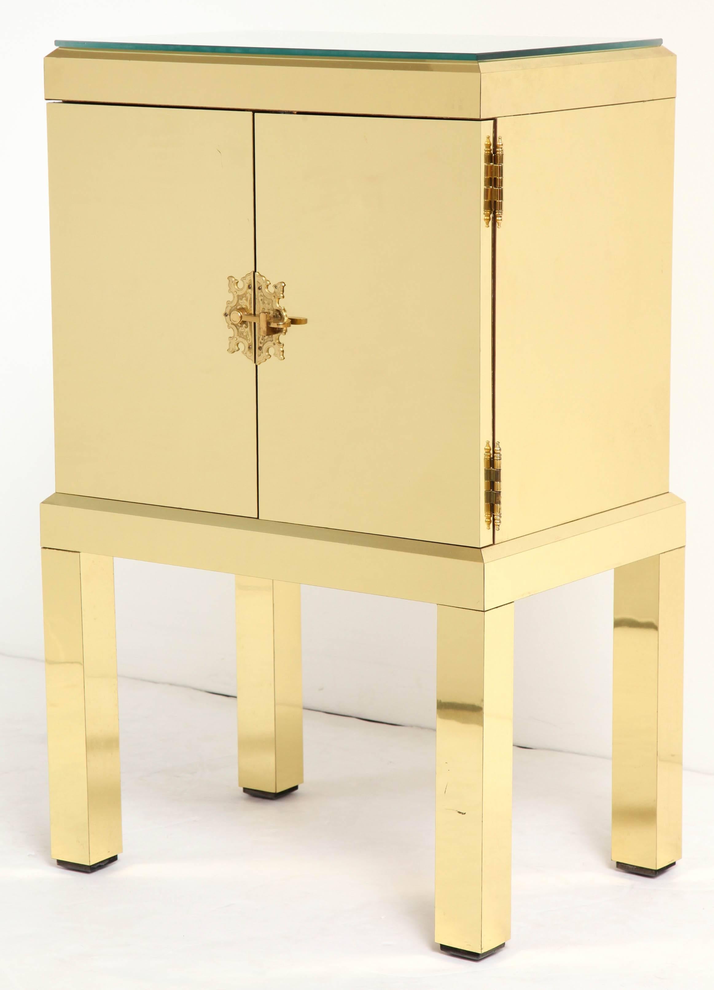 BG GALLERIES NEW YEAR SALE THROUGH FEBRUARY 29, 2024

Extremely stylish as well as functional two-door chest on four legs all clad in brass. Perfect for use as a telephone table or even as a single nightstand. Cut to fit glass top and a single