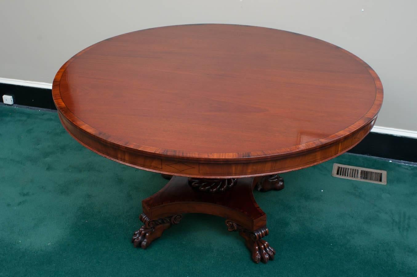 Mahogany with mahogany crossbanding and ebony line inlay, excellent carved feet and base, custom table pads included.