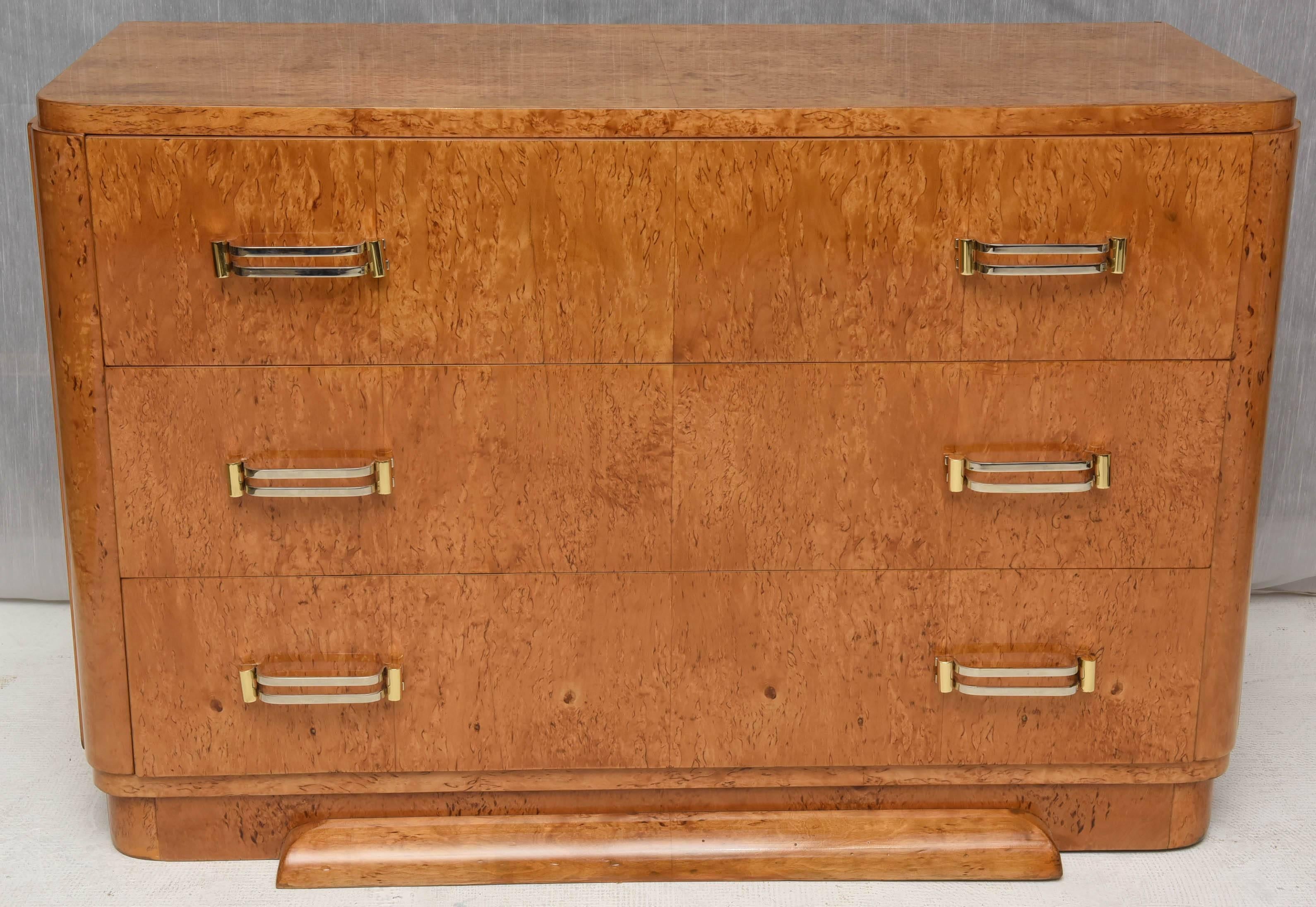 Unusual chest of drawers, 
elegant three drawers commode, 
French Art Deco piece  in light b url of Amboina.
The hardwares are elaborated made of two colors metals. The size and the proportions are perfect.