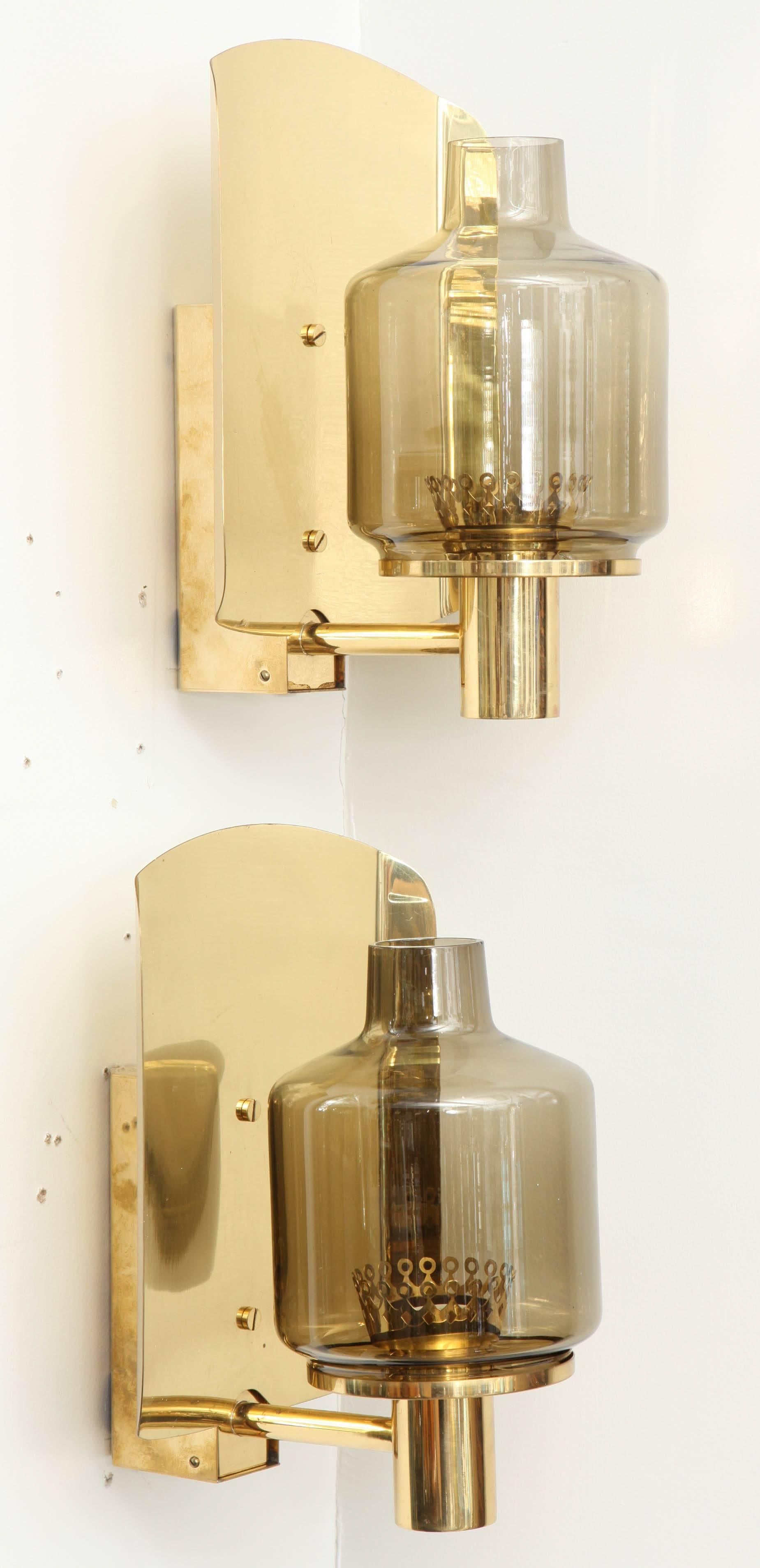 Pair of large-scale sconces composed of smoked glass globes on brass supports. Rewired for use in the USA.