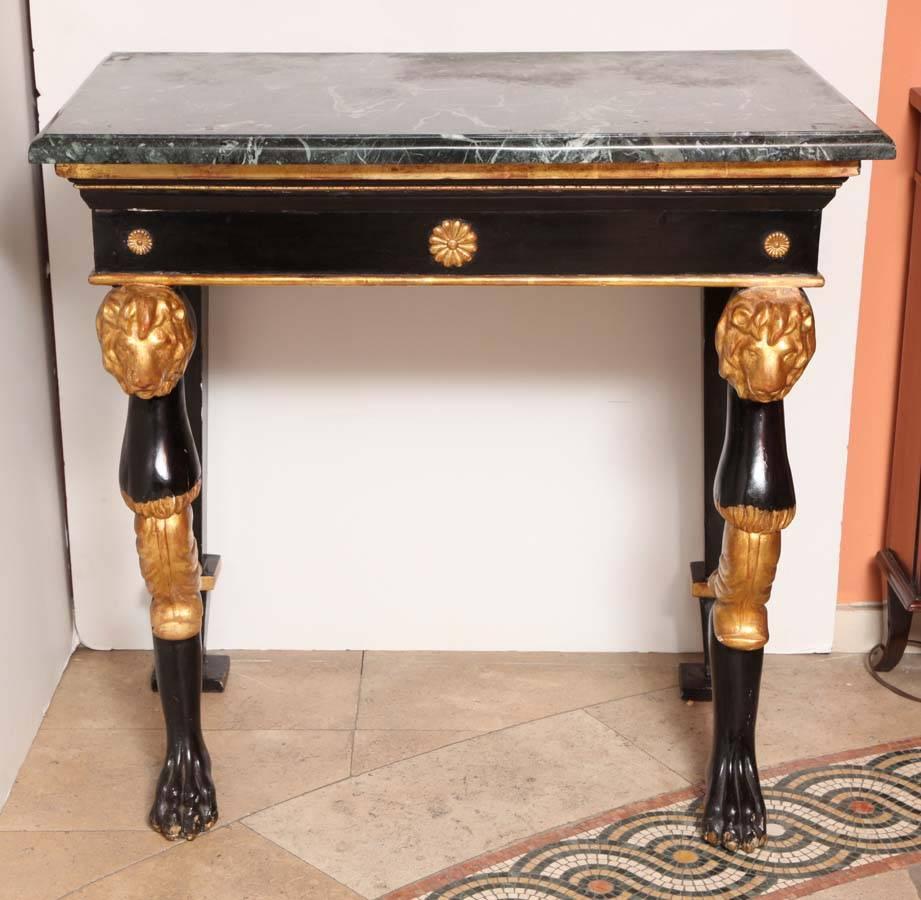 A fine English Regency marble top carved lion head and paw foot console table. In the manner of Thomas Hope.