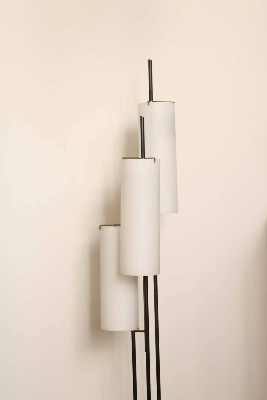 Modernist floor lamp made in Milan, 1950 by Stilnovo, three way light  switch, white glass shades, black finish stem with brass on a white marble base, great quality. 