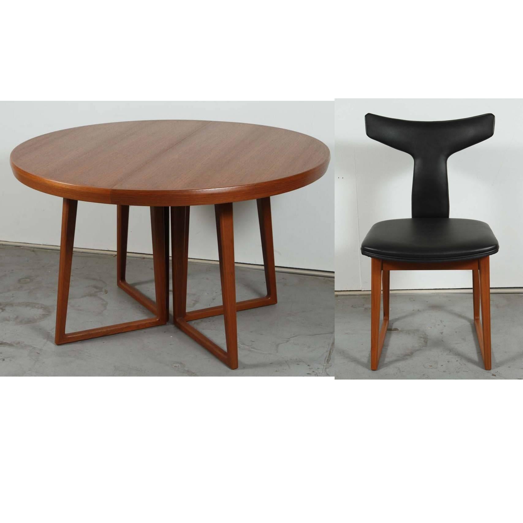 This amazing and quite rare Danish Modern dining set by Arne Vodder includes: One Mid-Century refinished teak expanding dining table (with two leaves) and six newly upholstered black vinyl dining chairs (as was found on chairs originally). Starts as