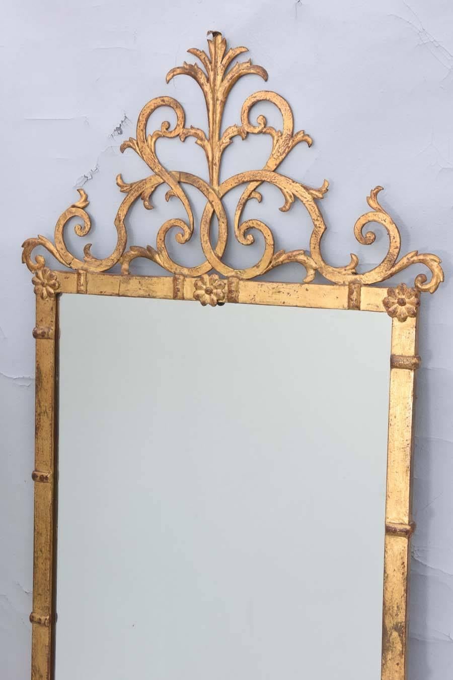 Wall mirror, having a rectangular plate in frame of gilded iron decorated by bars and flourished corner-pieces, surmounted by elaborate pierced scrolling pediment of acanthus and curls. Impressed mark on back, "Palladio".

Stock ID: #D9308