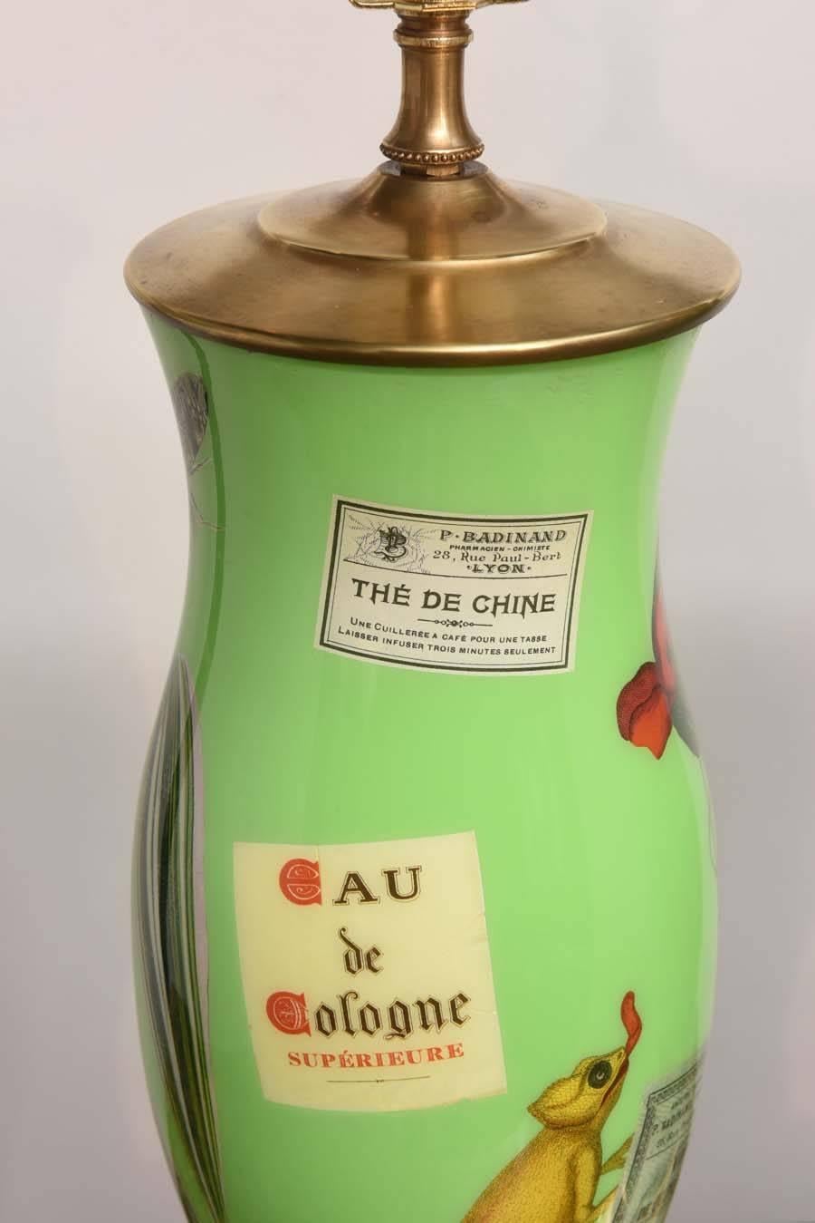 Exquisite pair of green glass decoupage lamps with whimsical designs.  Gilded wood bases with brass tops and sockets.