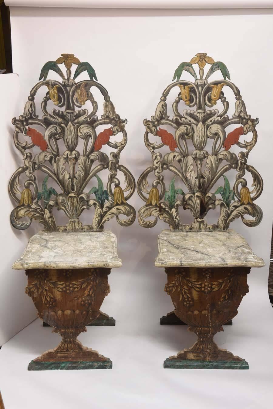 Unique pair of carved and pierced wood side chairs. Beautifully painted by an artisan featuring faux marble seat supported by a garden urn.