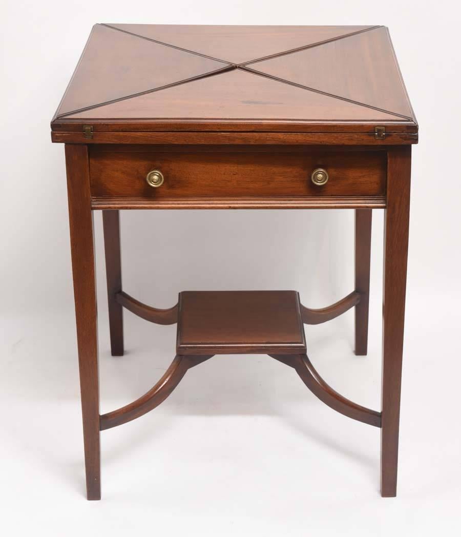 Charming side table with a folding handkerchief top that opens and turns to become a game/card table.