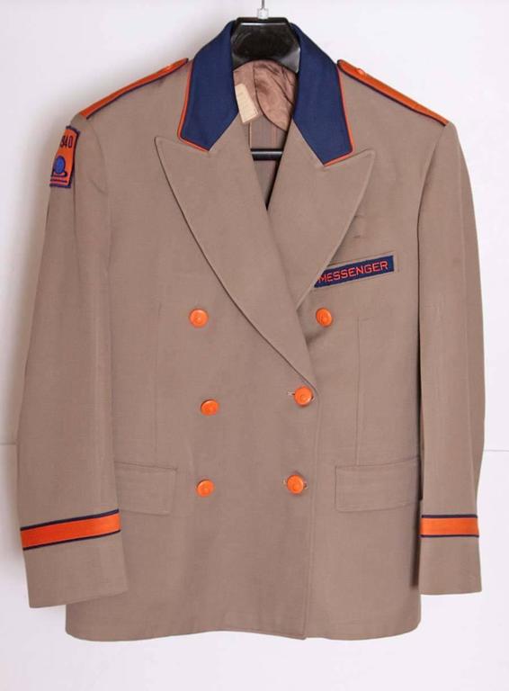 This is a great Historical thing.
Heavy cotton-twill khaki jackets with felted-cotton and silk ribbon trim, orange catalin Trylon & Perisphere buttons, partial silk/rayon inner linings. 

Men's double-breasted 