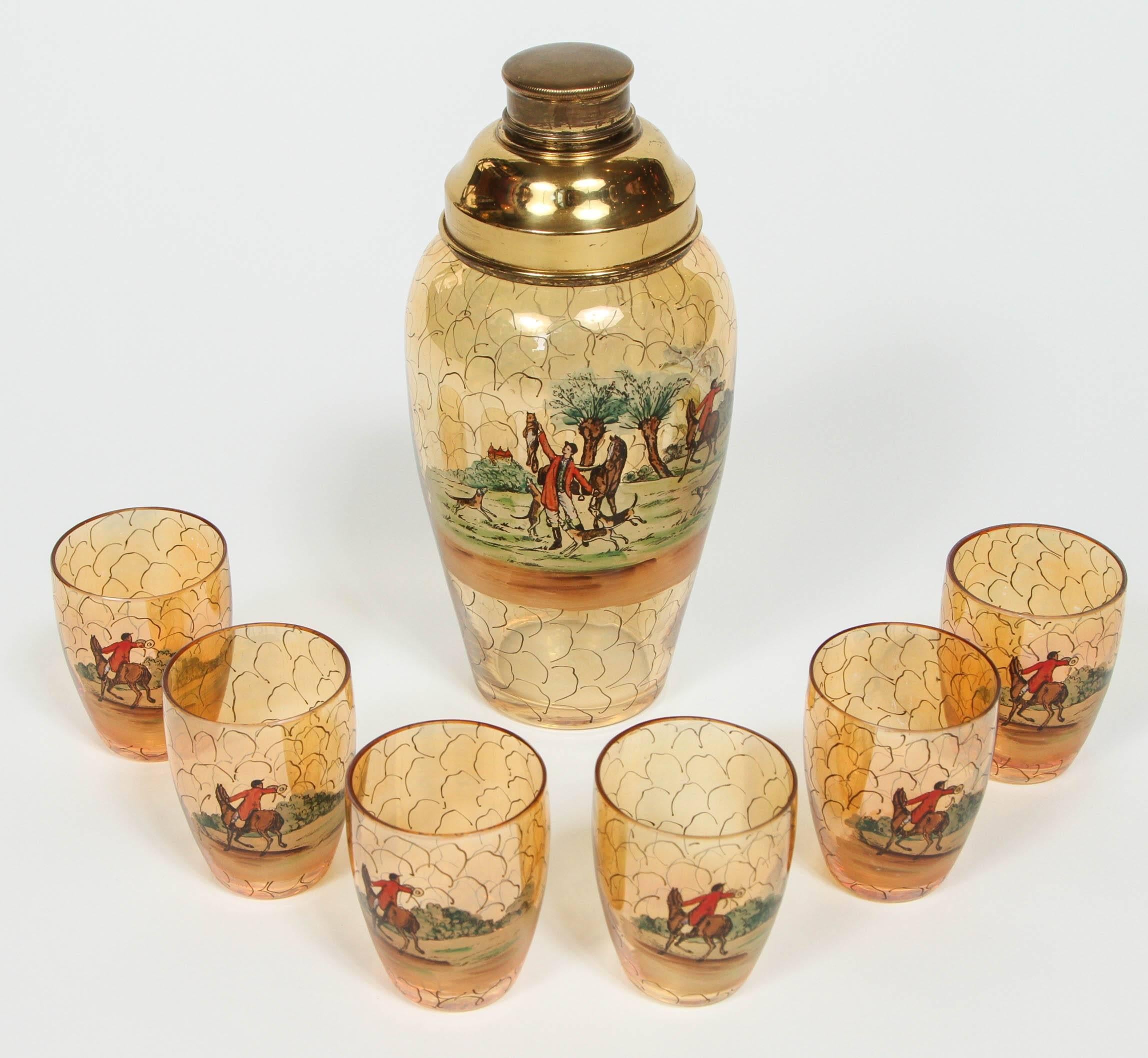 Antique martini shaker with brass top and six glasses. All pieces have a hunting scene design.