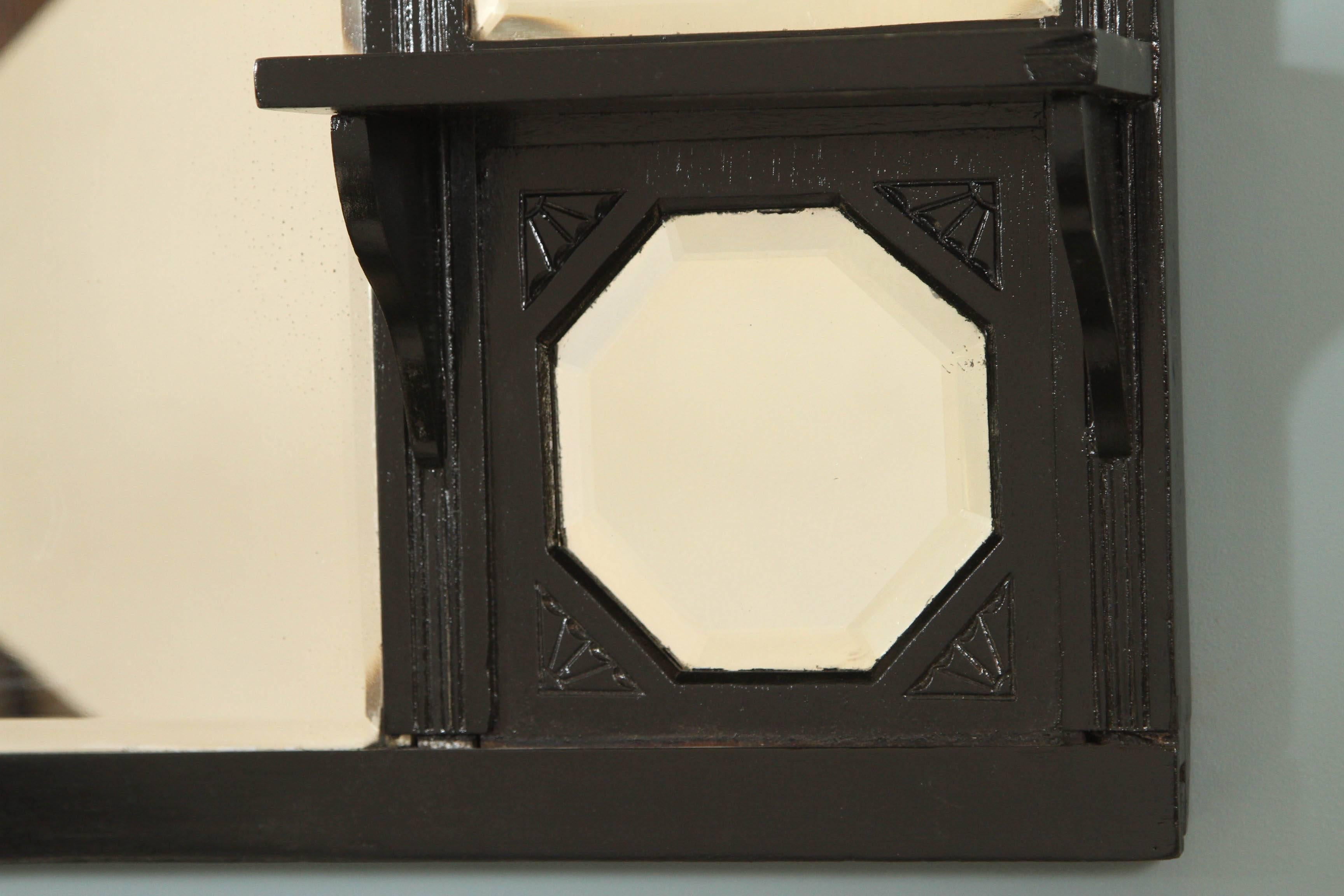 Antique Eastlake walnut mirror with small shelves and original beveled mirrors. Newly painted in a black finish. 
