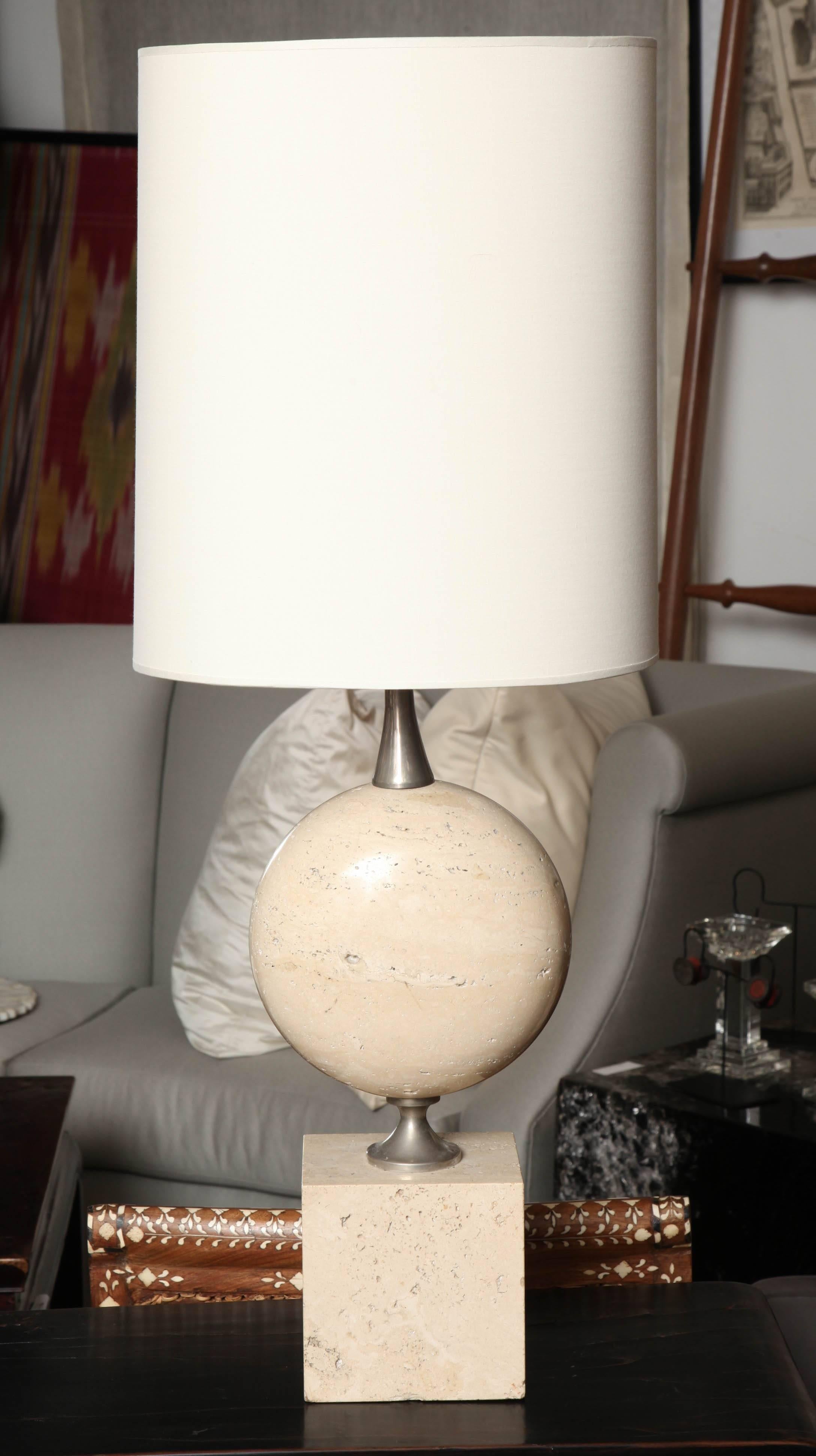 A table lamp from Maison Barbier with a limestone base and oblong shade.