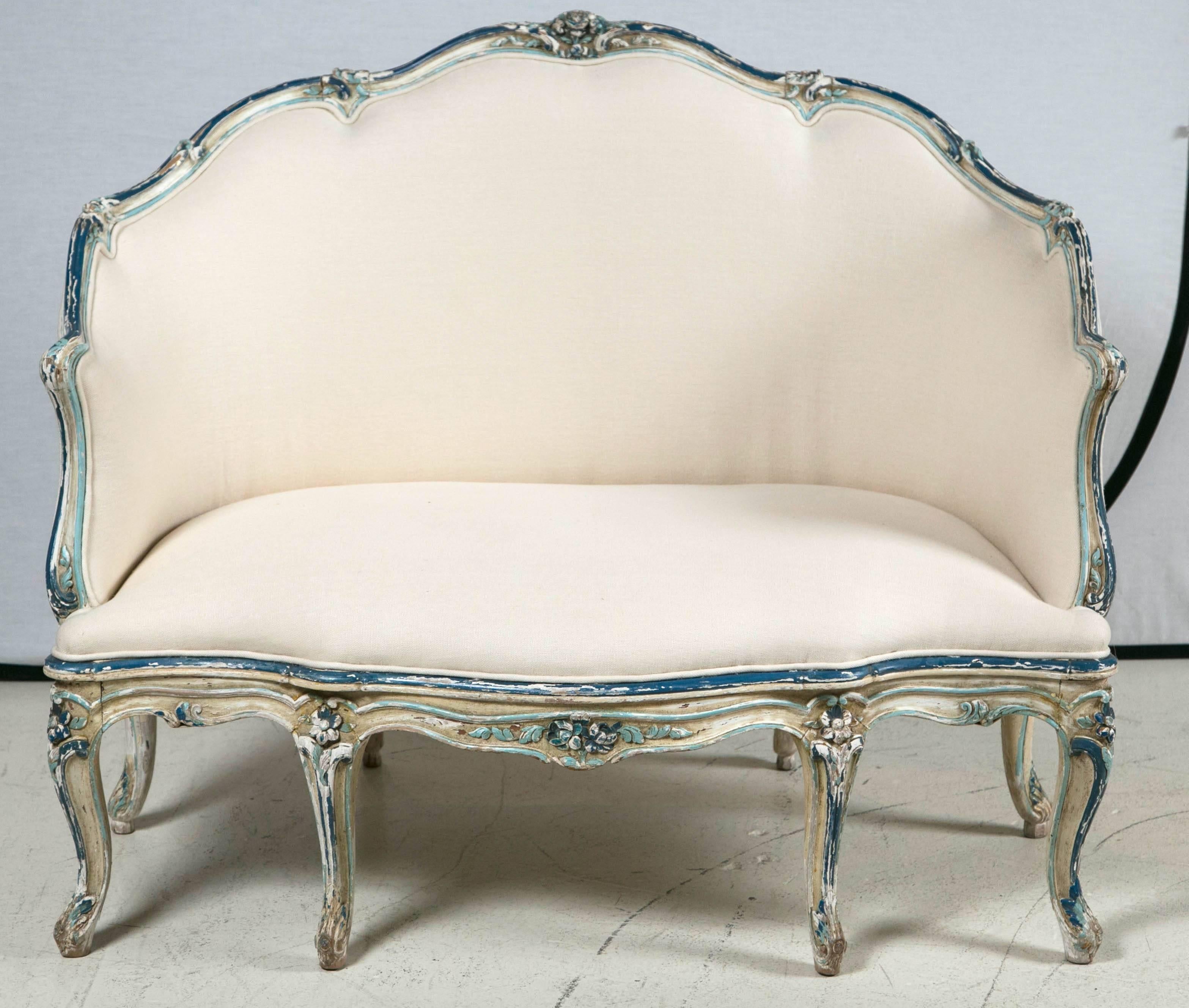 Hand-carved and painted in blue hues. Newly upholstered.
