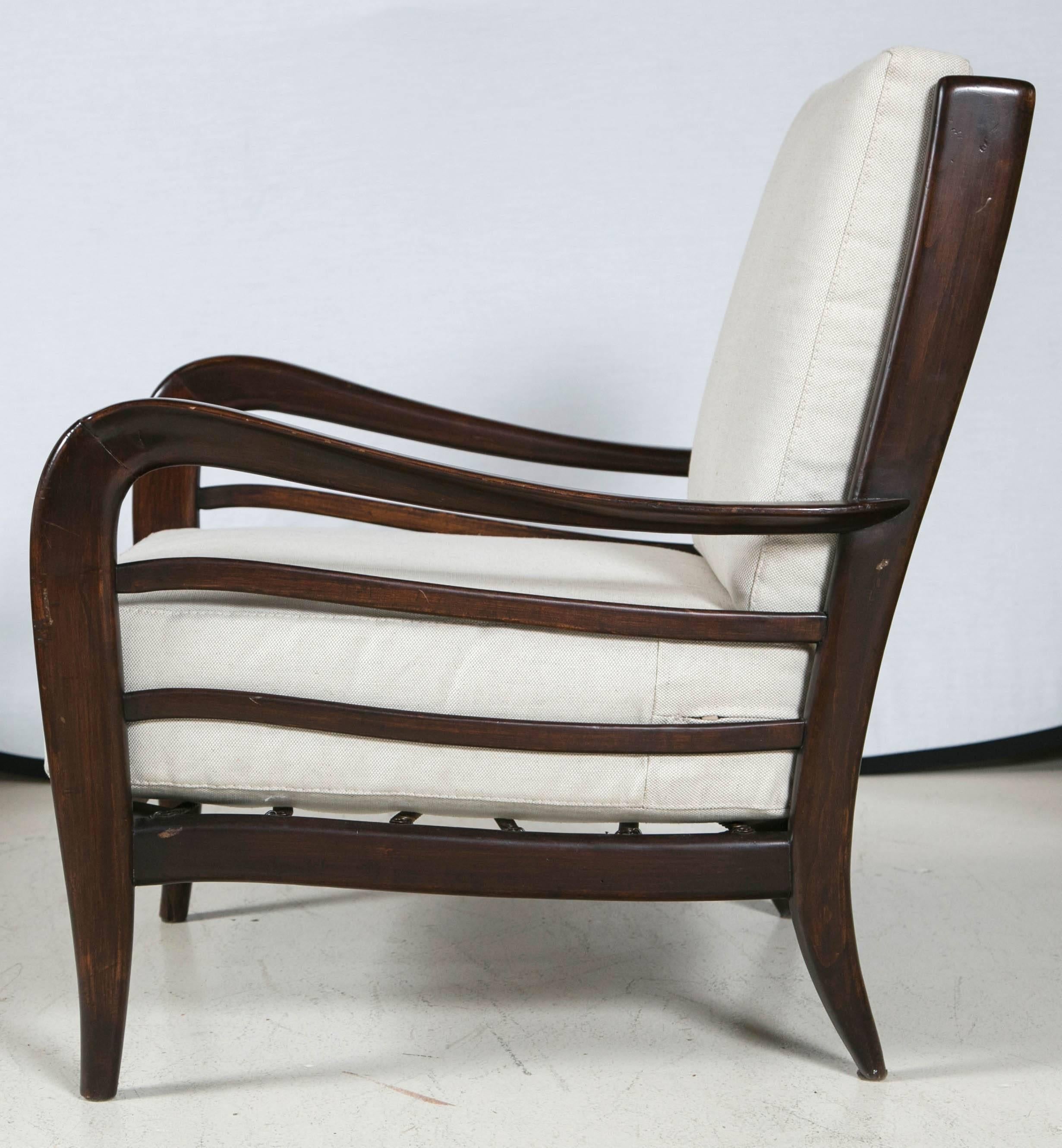Pair of lounge chairs attributed to Paolo Buffa, with newly upholstered removable cushions and sculpted wood frames.