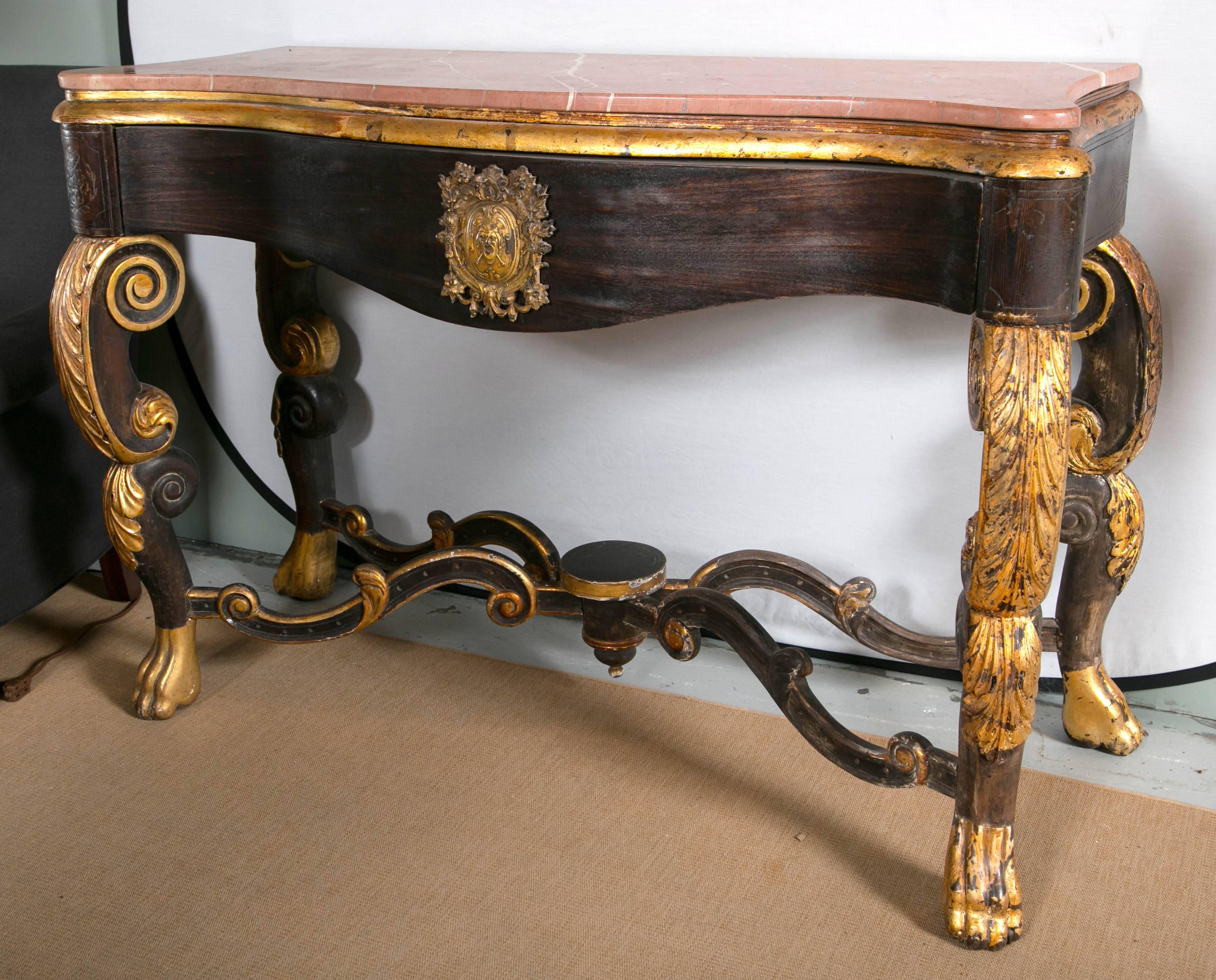 Marble-top console with carved and gilded legs.
 