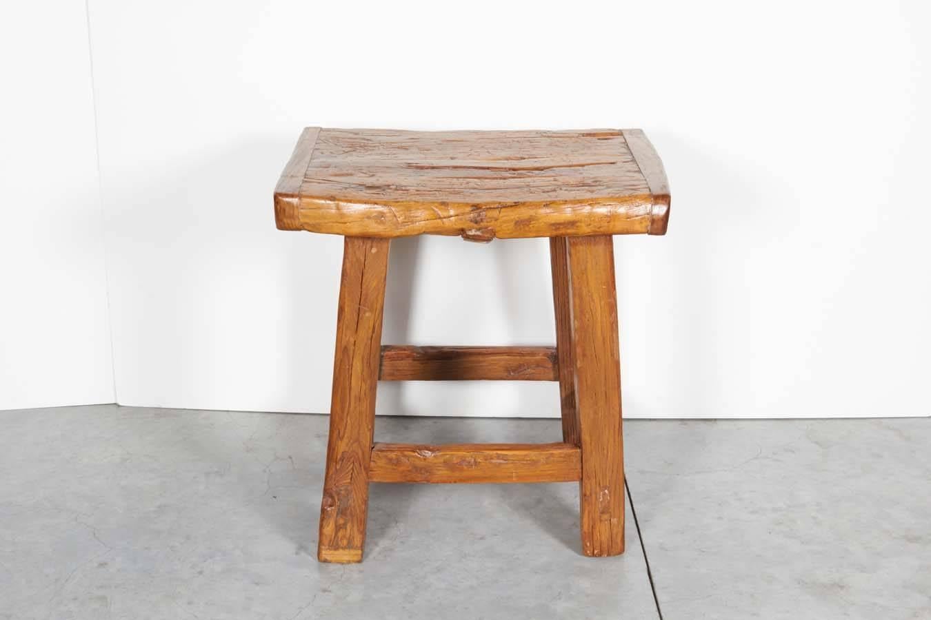 A large antique Chinese stool with a solid two inch thick seat, easily usable as a side table. Great patina. From Shanxi Province, circa 1900.
S488.