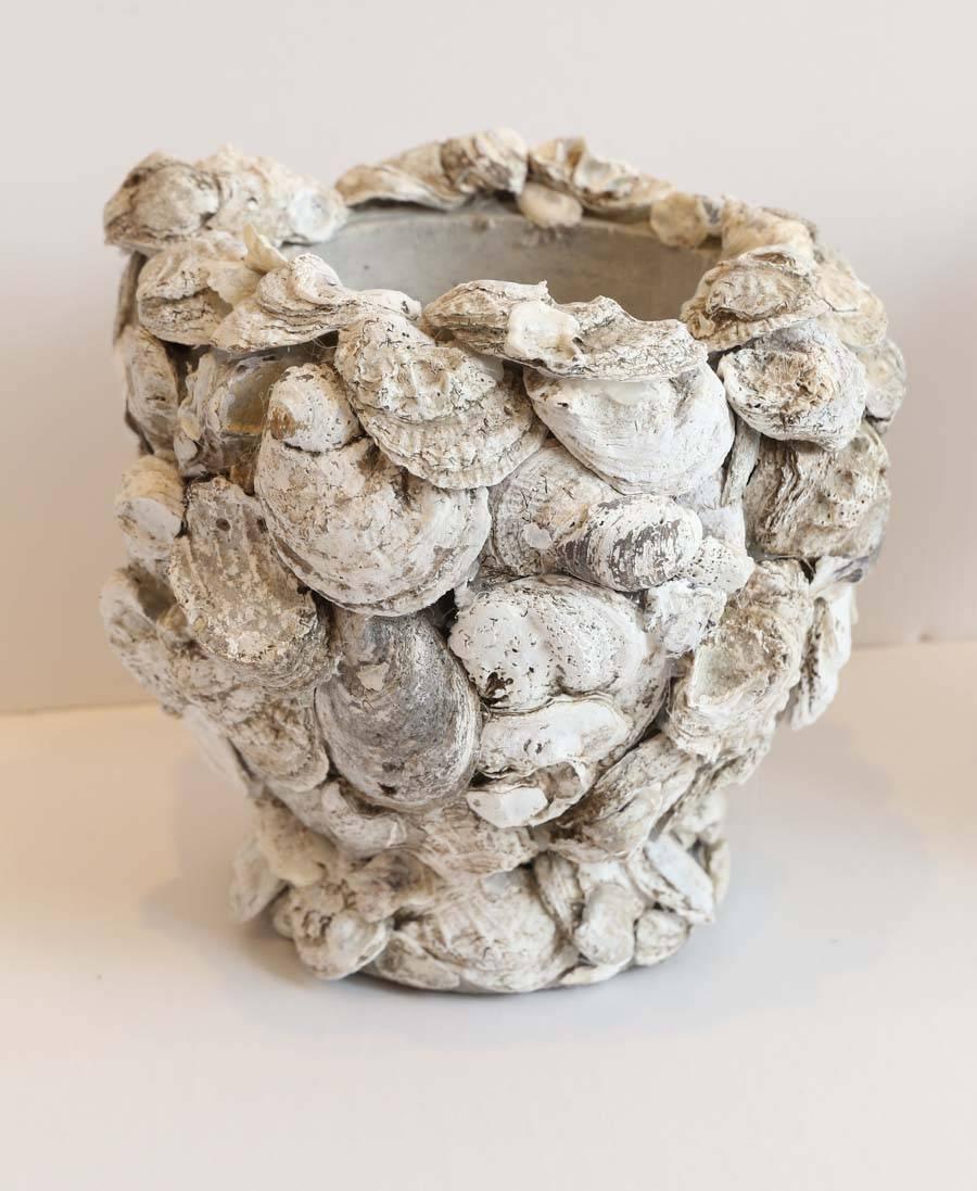 Pair of concrete cachepots covered in oyster shells, fits six inch diameter pot.