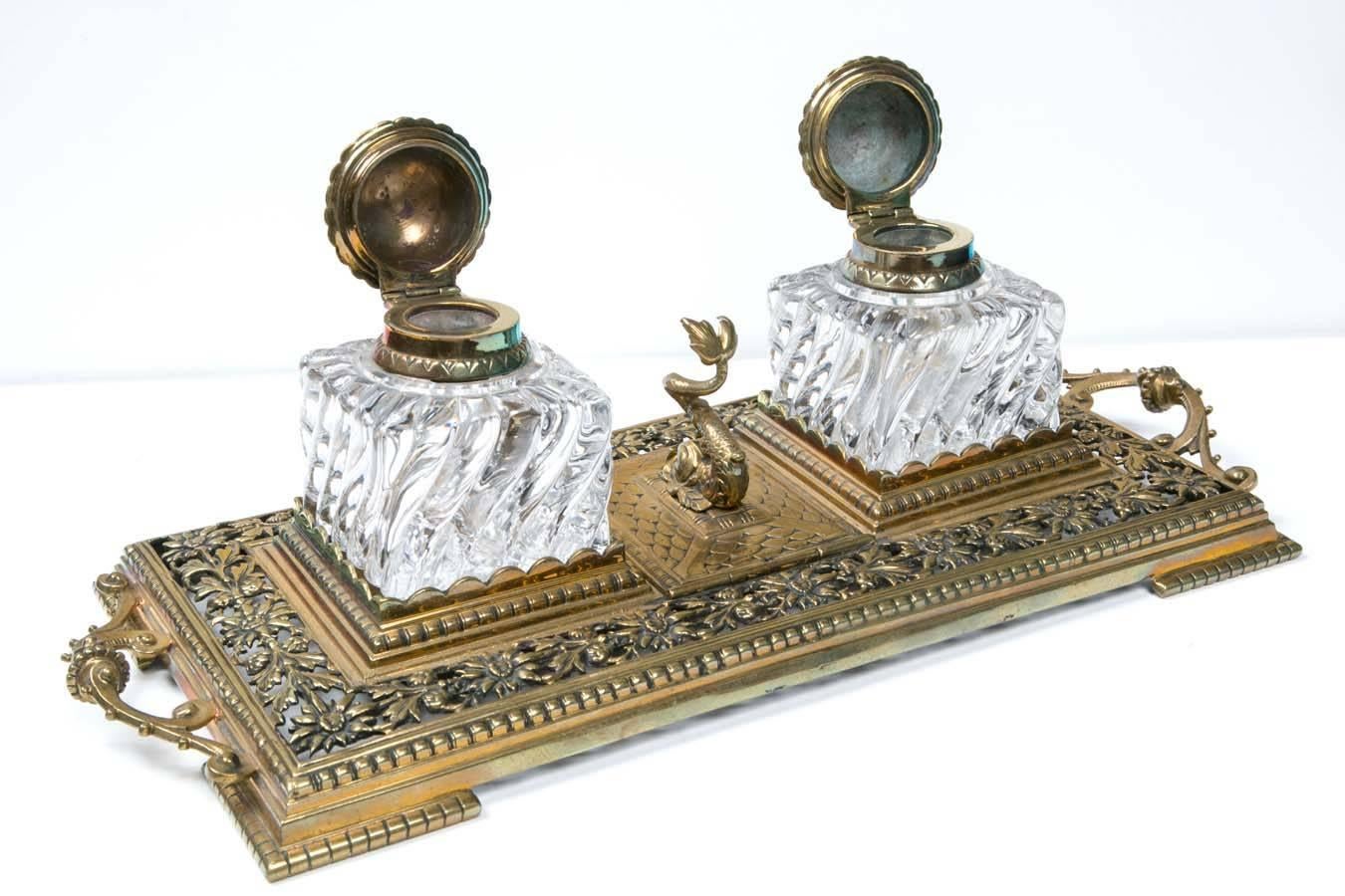 This is just one of a 350 piece collection of 18th-19th century antiques from a private collector. 19th century crystal inkwells in brass tray with sturgeon stamp holder. It has two cut-glass inkwells with brass caps on a brass tray. A beautiful