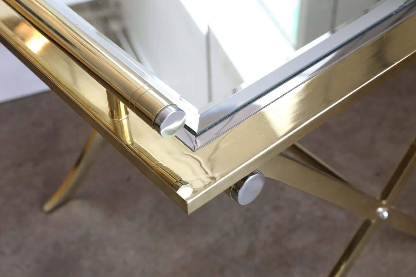 Offered is a glamorous chrome, brass and mirror tray sitting atop a brass and chrome "X" base made by Design Institute America. This high fashion piece would look great as a side table, nightstand, tray table, bar cart or small vanity