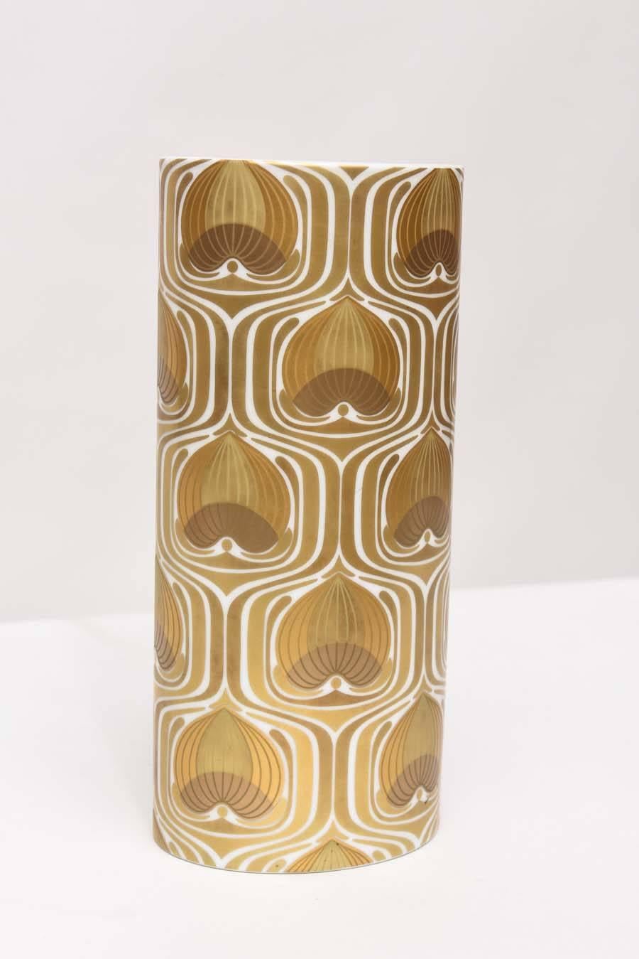 Oval cylinder vase designed by Bjorn Wiinblad for Rosenthal, circa 1970. White porcelain with 24-karat gold decoration. Marked.