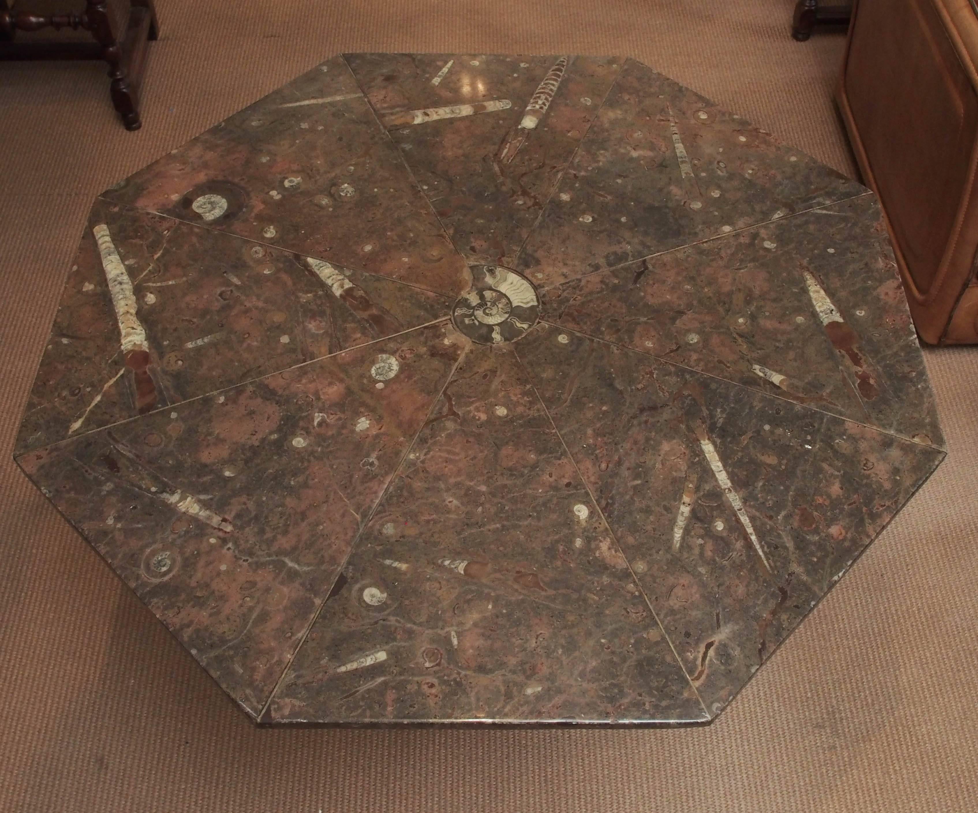 Octagonal table of fossil marble with metal base, Mid-Century, French. 40 inches in diameter by 28 3/4 inches high.