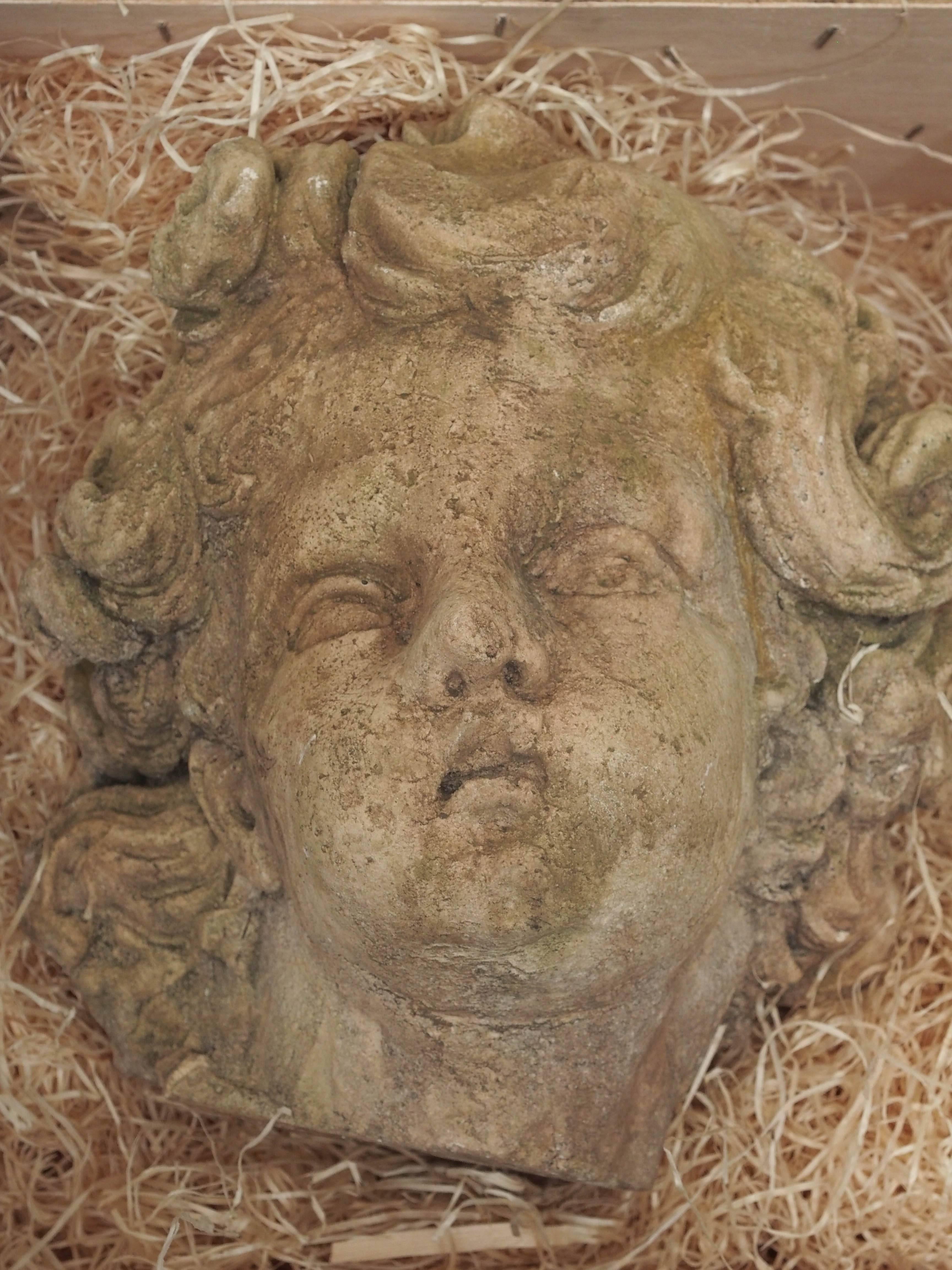 A plaster sculpted head of a cherub created during the late 19th century.
