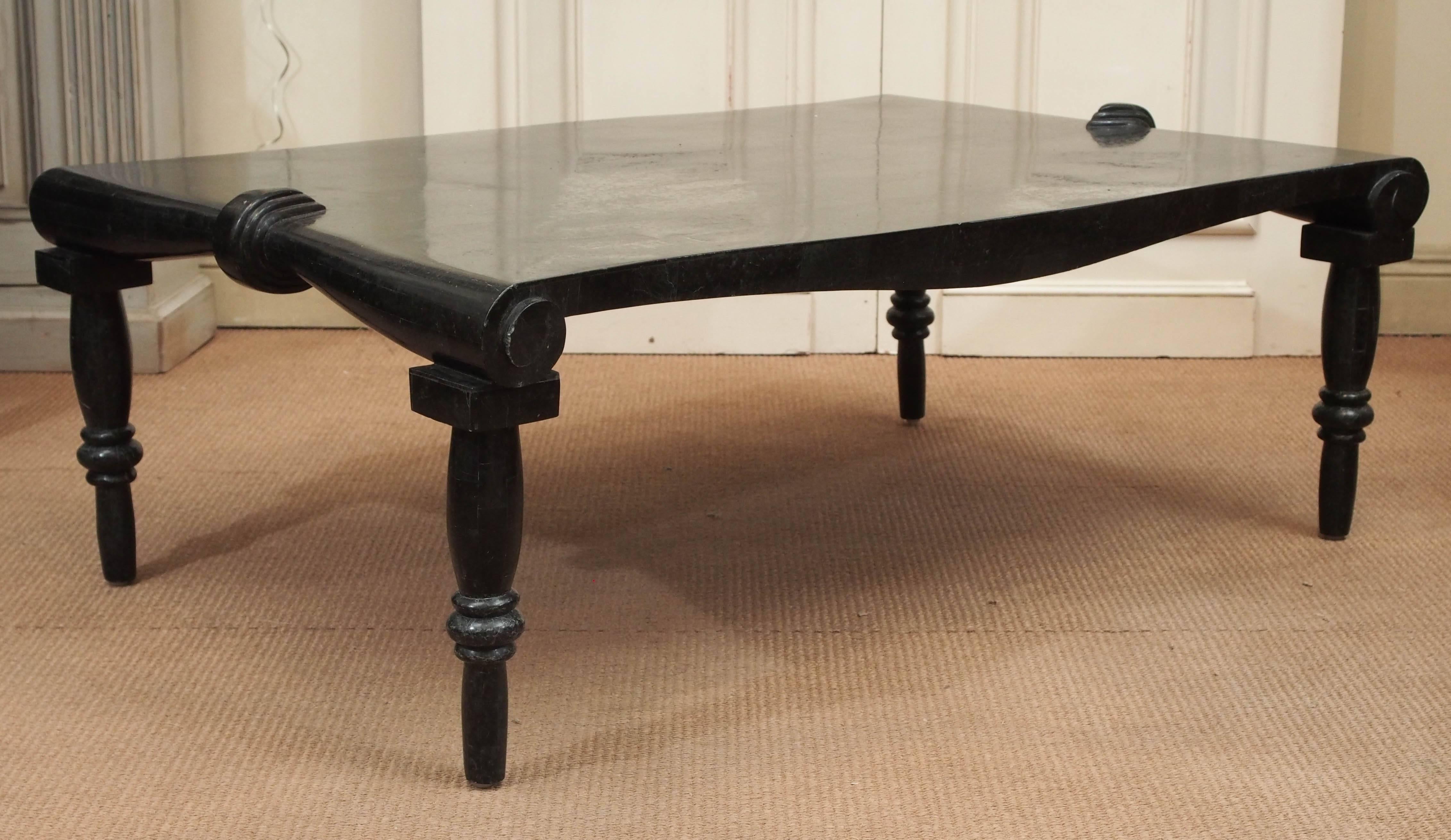 Black onyx coffee table with inlaid top and marble legs. The impeccably carved tapered legs feature scroll-work where they join to the top.

Italian, circa 1970