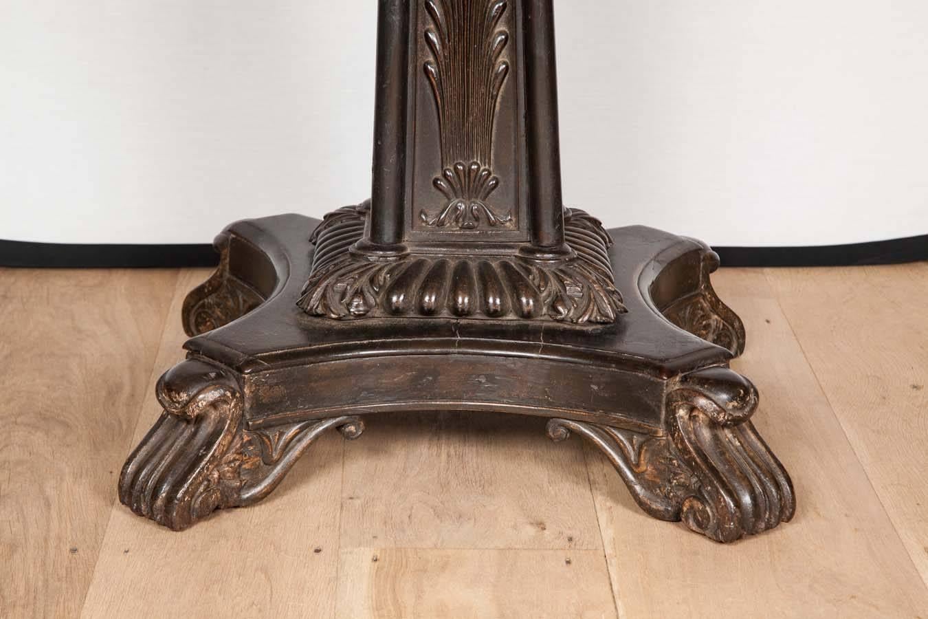 A 19th Century colonial table, probably from Calcutta attributed to Lazarus with rectangular top over carved centre column detailed with leaf carving over quatrefoil base on rolled and scrolled acanthus leaf carved feet.

Indian, circa