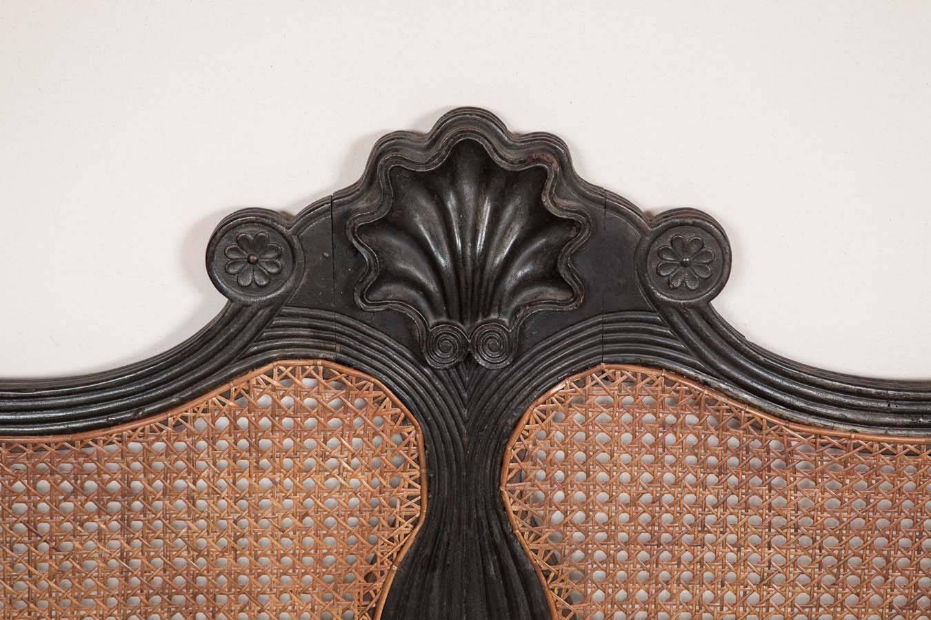 Back to view all New Arrivals
A 19th century ebonised carved Ceylonese settee

A mid 19th century large and heavily carved ebonised settee with shaped top rail with heavily carved central shell motif above a central fluted splat with caning to