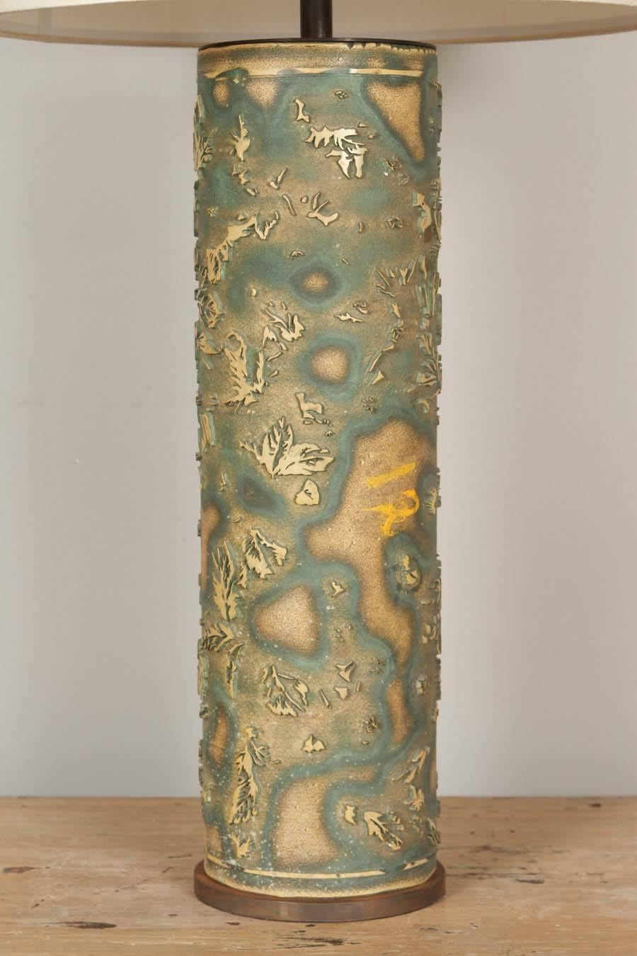 A green print roll converted into a lamp with custom silk shade.