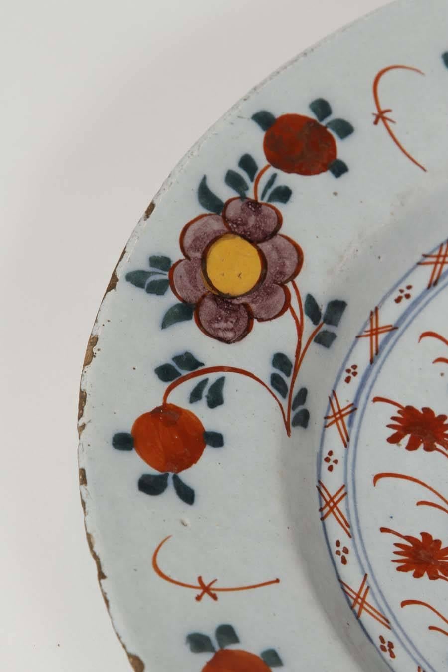 An 18th Century Dutch Delft Polychrome charger. The elements of the design are derived from Chinese porcelain, but the presentation is completely original.