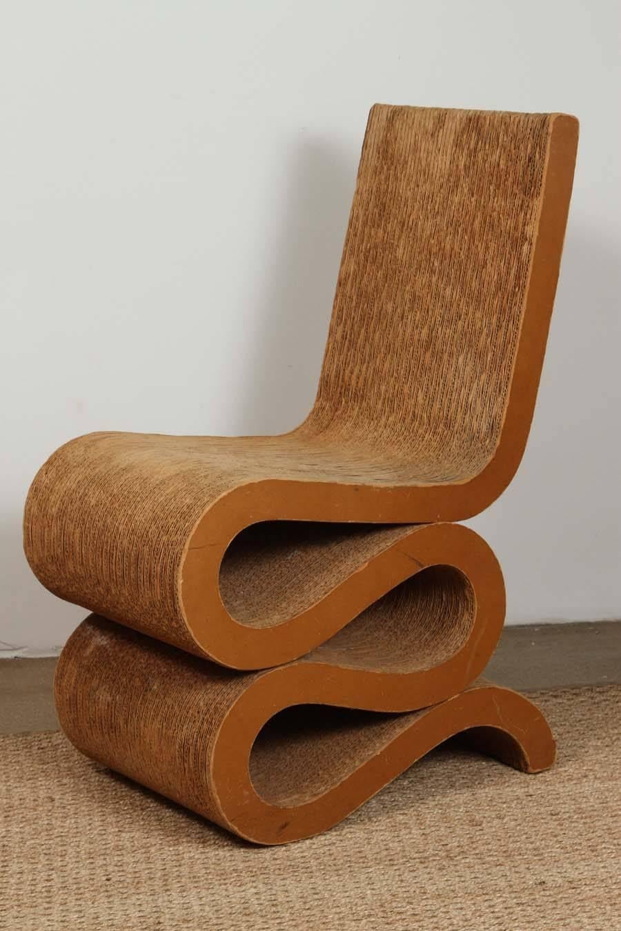 The Wiggle side chair, architect Frank O. Gehry's best-known design in cardboard, was designed in 1972. This example was produced by Easy Edges, Inc for Bloomingdale's. The cardboard seat and back have beautiful suede like patina. The condition is