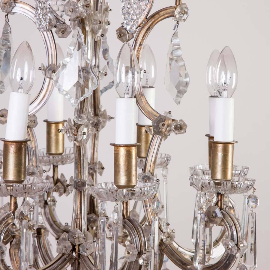 An eight-arm Marie Thérèse style crystal chandelier, French, circa 1910.

With stylised bunch of grapes shaped drops.

This chandelier formerly hung in a restaurant in Tivoli Gardens, Copenhagen.

Tivoli Gardens (or simply Tivoli) is a famous
