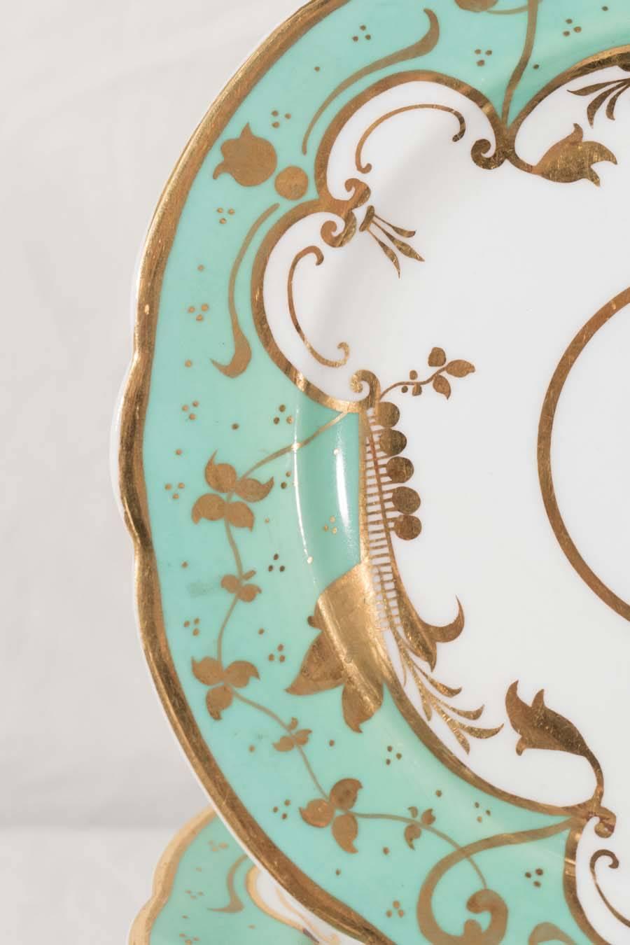 Ten sea foam green dishes with a Victorian design of gilded leaves and flower heads. These small dishes would be perfect hors d'oeuvres or small desserts.
 