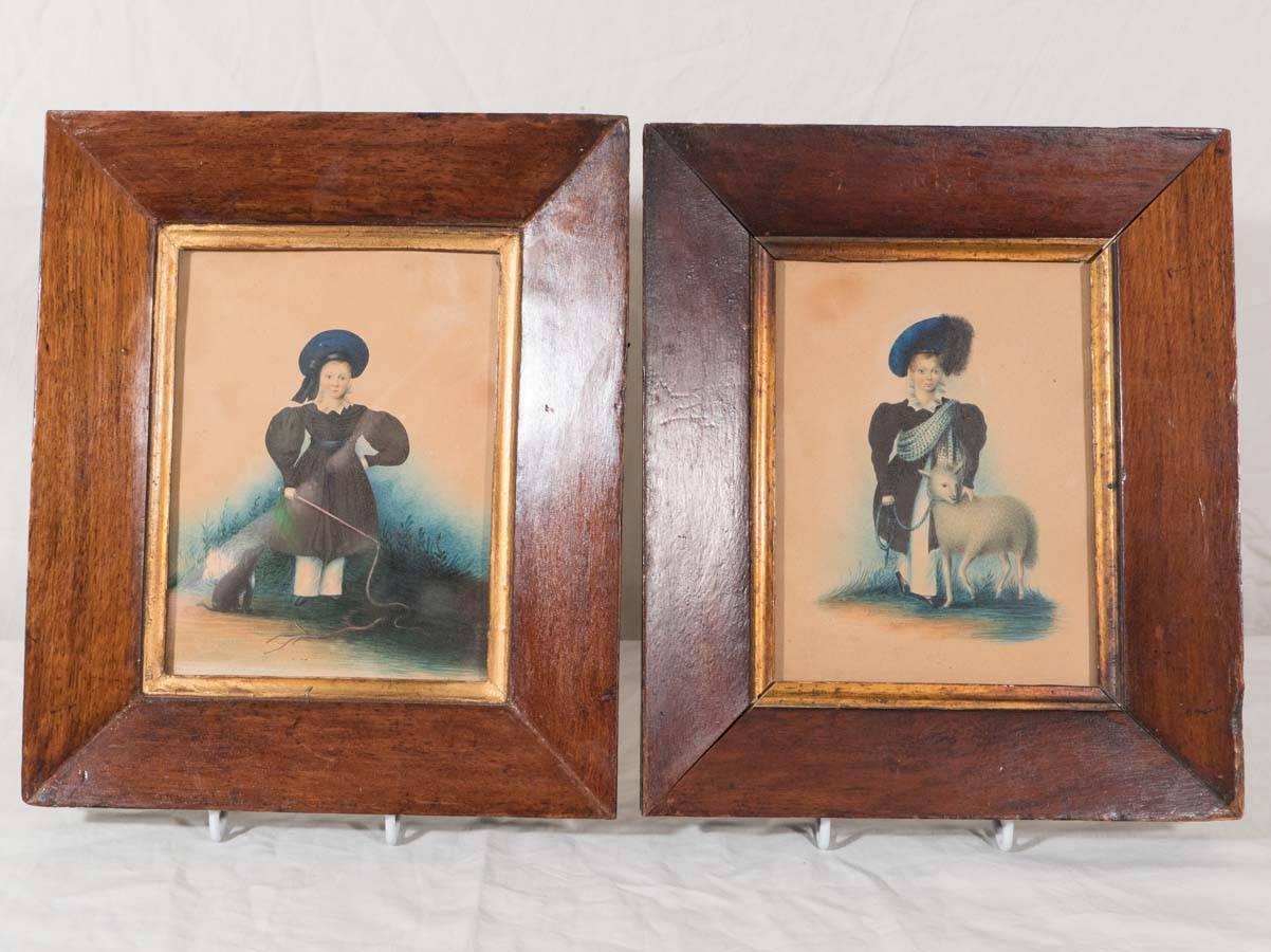 This pair of watercolor portraits is signed and dated 1834. 
They show two young Scottish shepherd boys (possibly brothers?). Each boy wears a blue tam o' shanter.*
 One portrait shows a young boy standing with his dog and holding a whip. The
