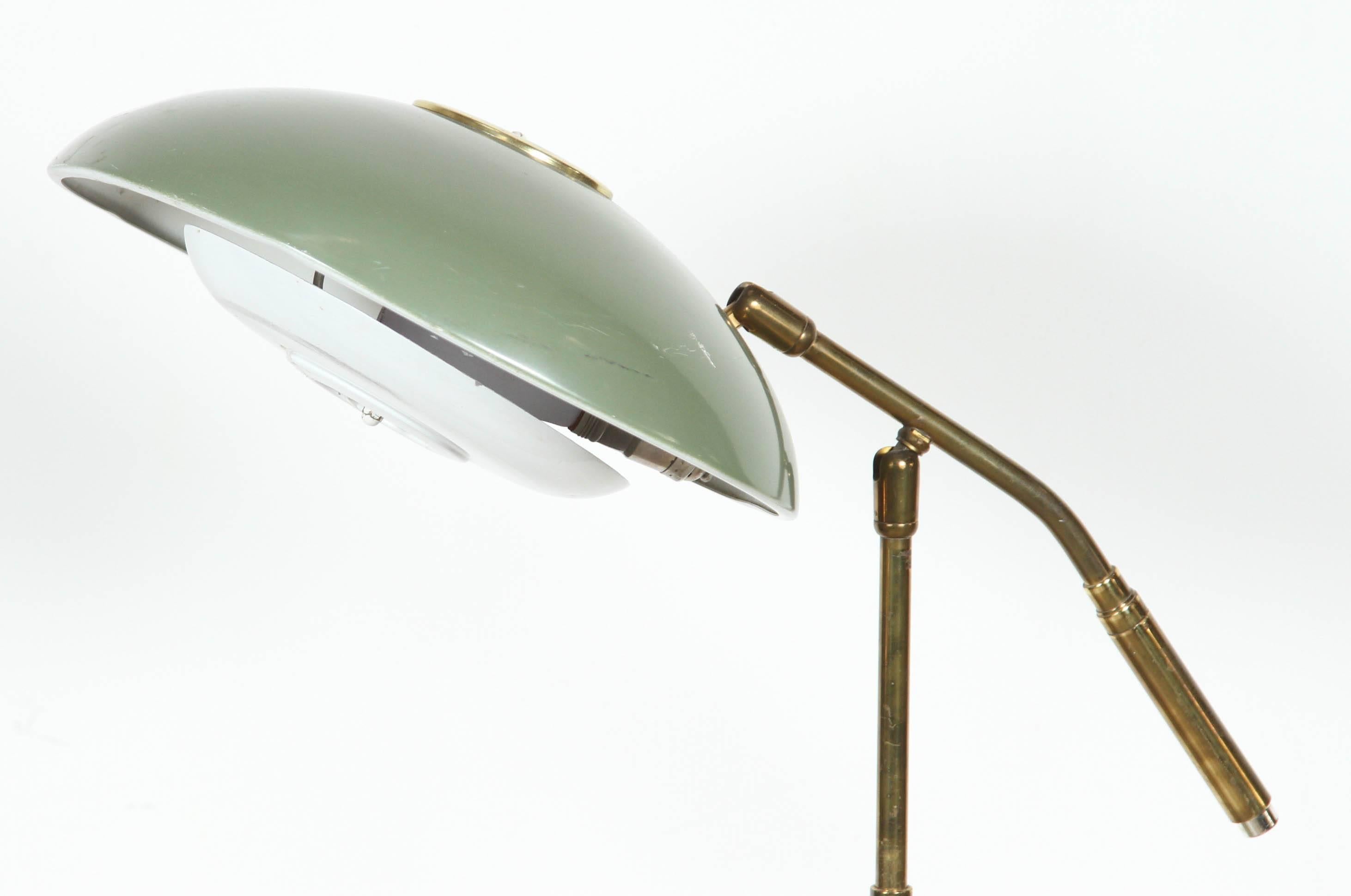 Mid-Century Modern Gerald Thurston floor lamp for Lightolier.
Enameled green metal with brass details and perforated metal.
Pole extends to 52 inches. Shade swivels in all directions. 
Base is 10" diameter.
Shade is 12" diameter.