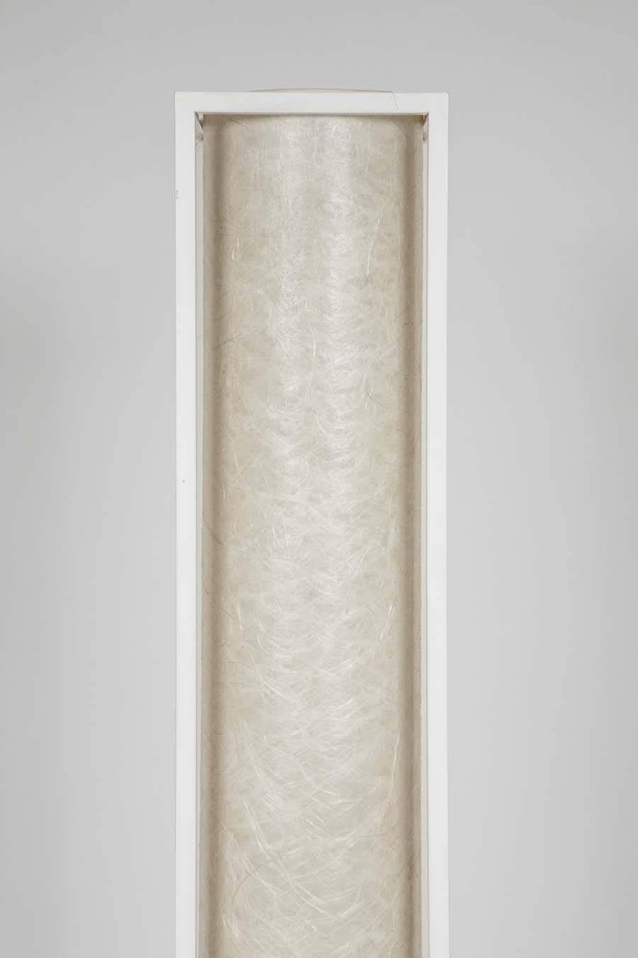 With its clean lines and Minimalist design this slim lamp fits easily into any space. Encased in the rectangular white metal frame a cylinder of natural paper shades the light source giving off a beautifully soft glow. 

.