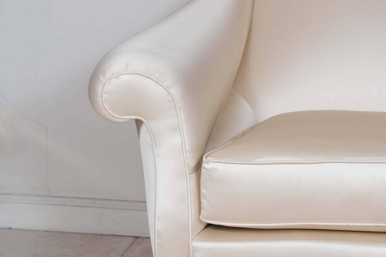 Pair of scrolled back, curvilinear armchairs in the style of Carlo di Carli.