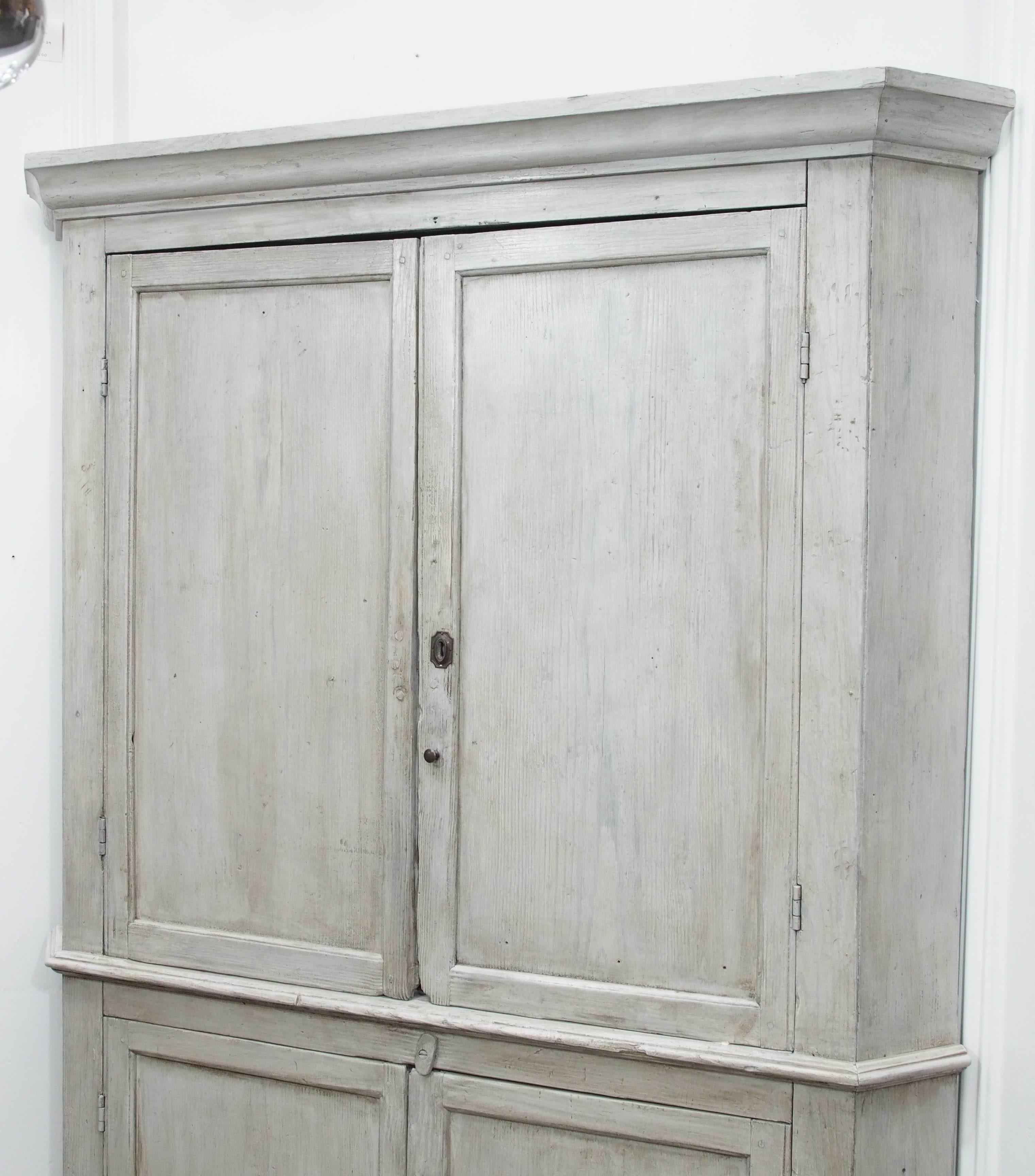 Early English white wash corner cupboard with scalloped base. The inside is large with three shelves on the top and one dividing shelf on the bottom. Beautiful details and construction.