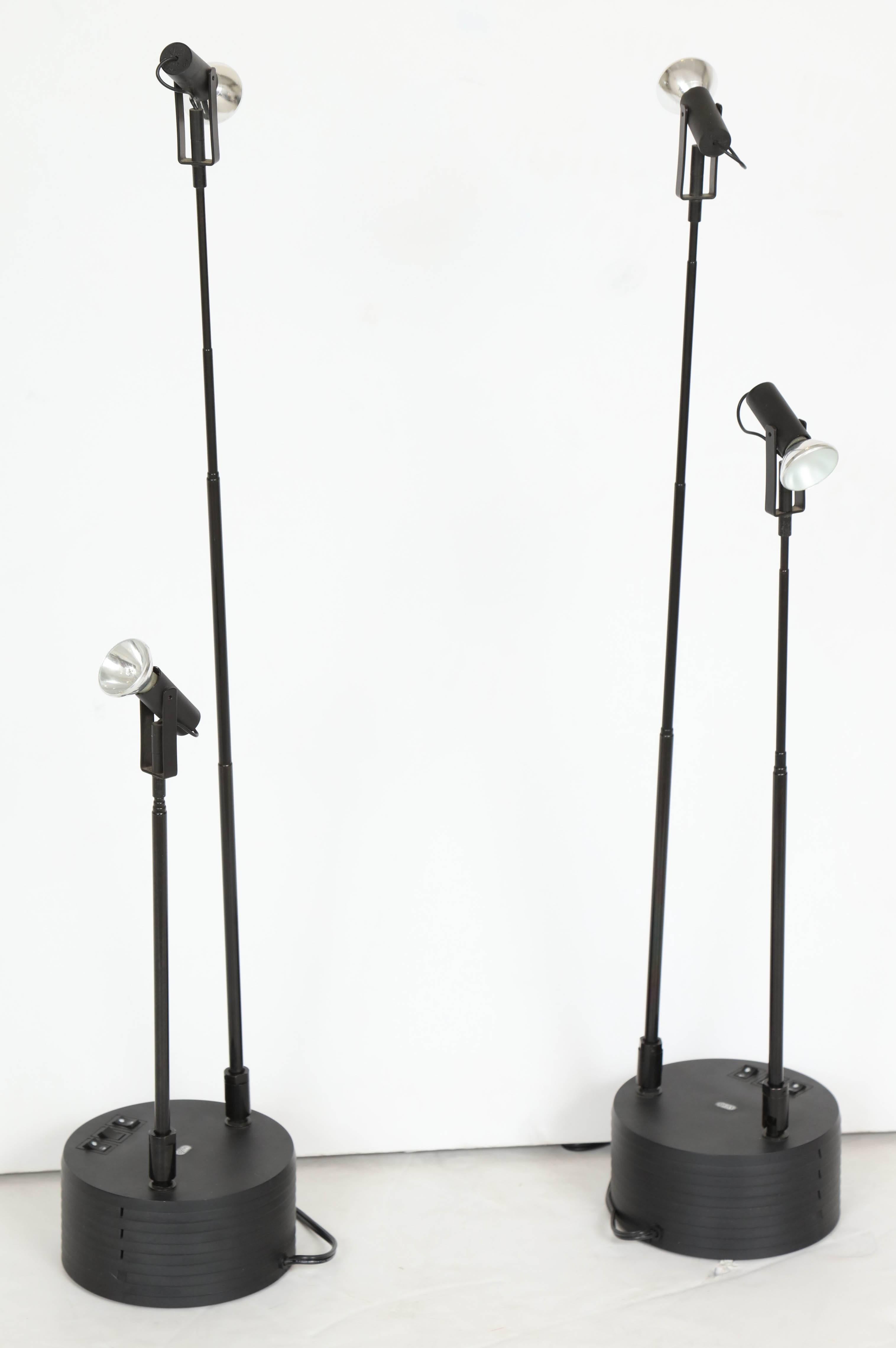 Black resin cylinder bases support two telescoping and articulating arms topped with miniature halogen reflector bulbs. Arms pivot at base and can be extended from 17 inches to a maximum of 41 inches as desired. Designed by Hans Ansems (Dutch, b