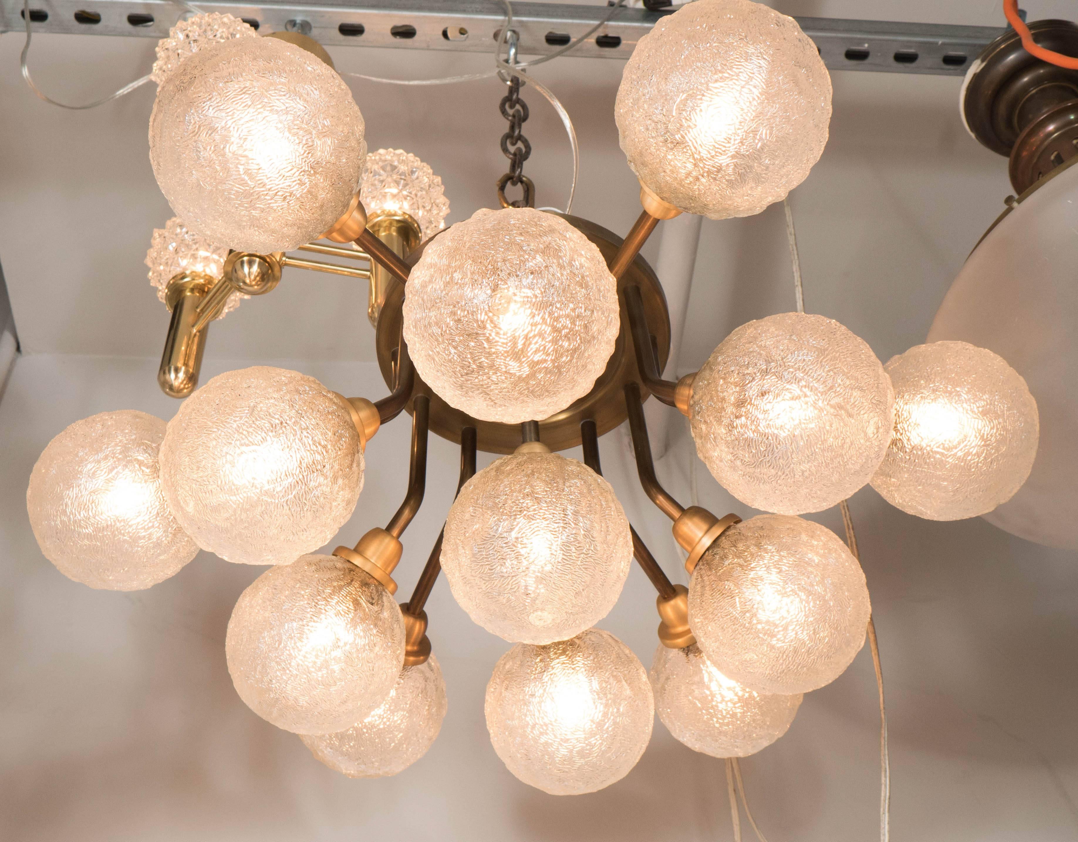 Mid-Century Patinated Twelve Arm Brass Flush Mount Chandelier w/ Textured Globes In Excellent Condition In New York, NY