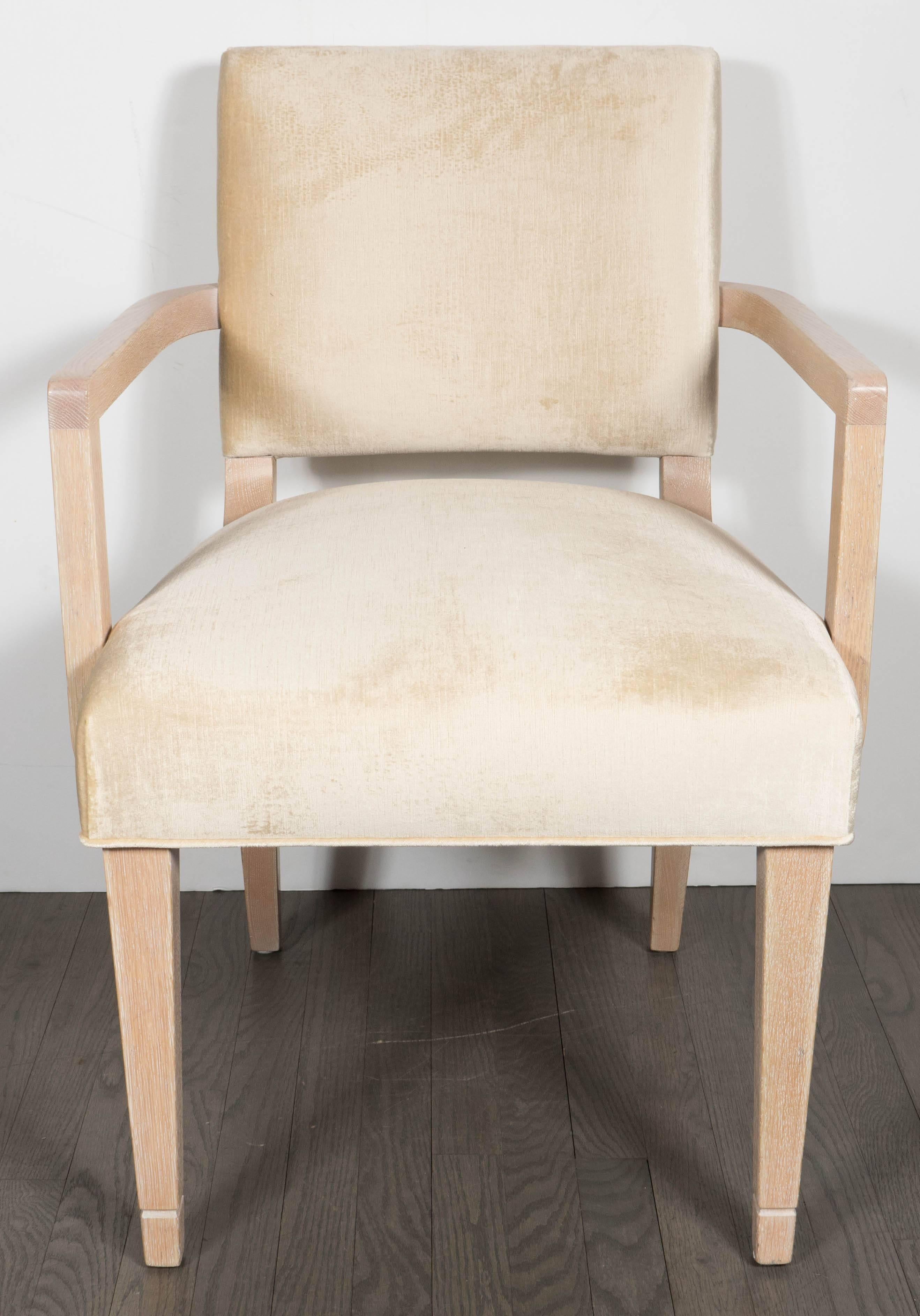 A gorgeous and very rare set of eight dining chairs in cerused white oak by Dorothy Draper for Schmieg & Kotzian. New pearl oyster velvet upholstery covers the seats and backs. Slightly splayed rear legs and minimally detailed front legs support